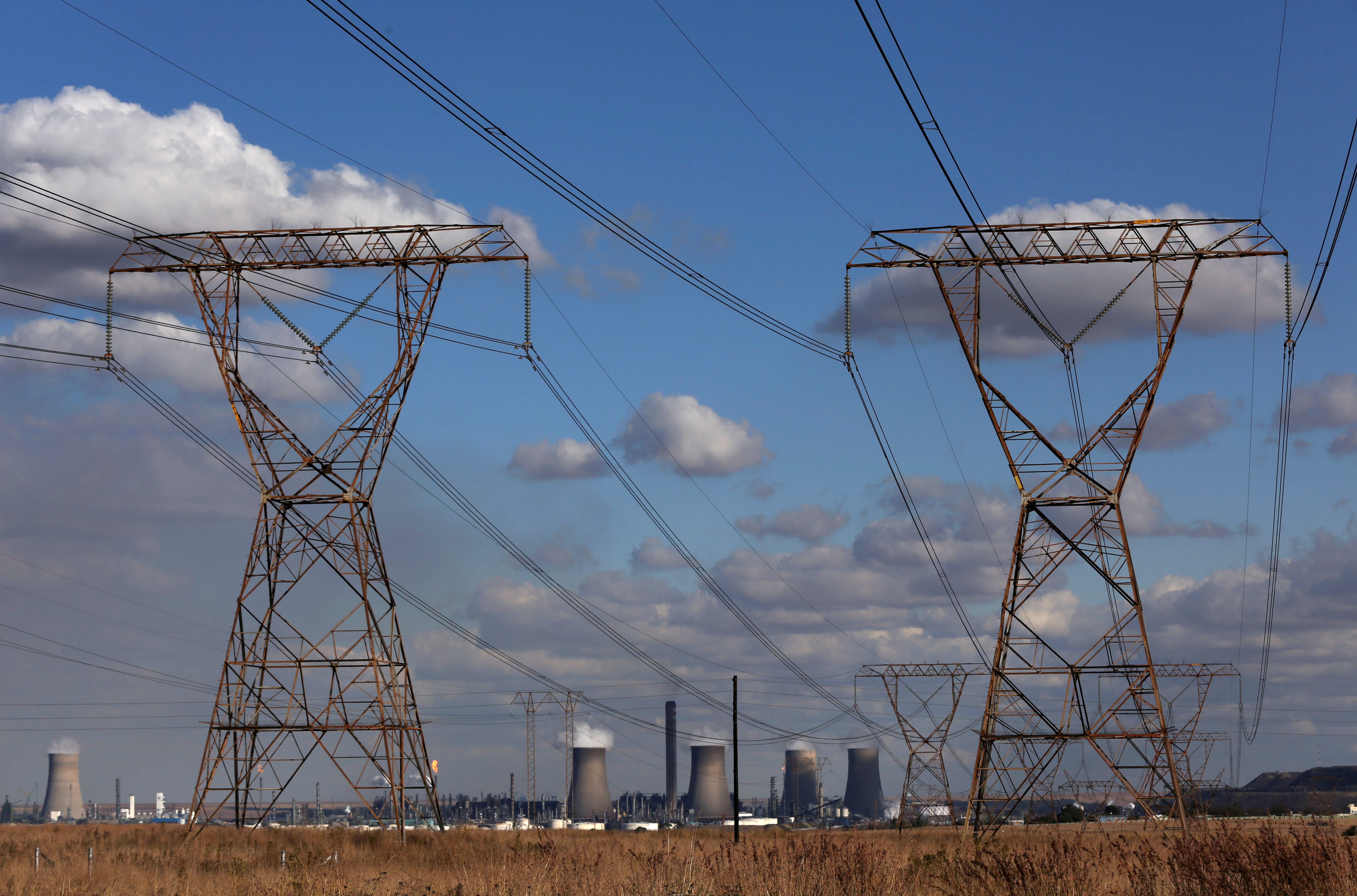 Electricity pylons are seen near cooling towers of South African petrochemical company Sasol's synthetic fuel plant in Secunda, north of Johannesburg
