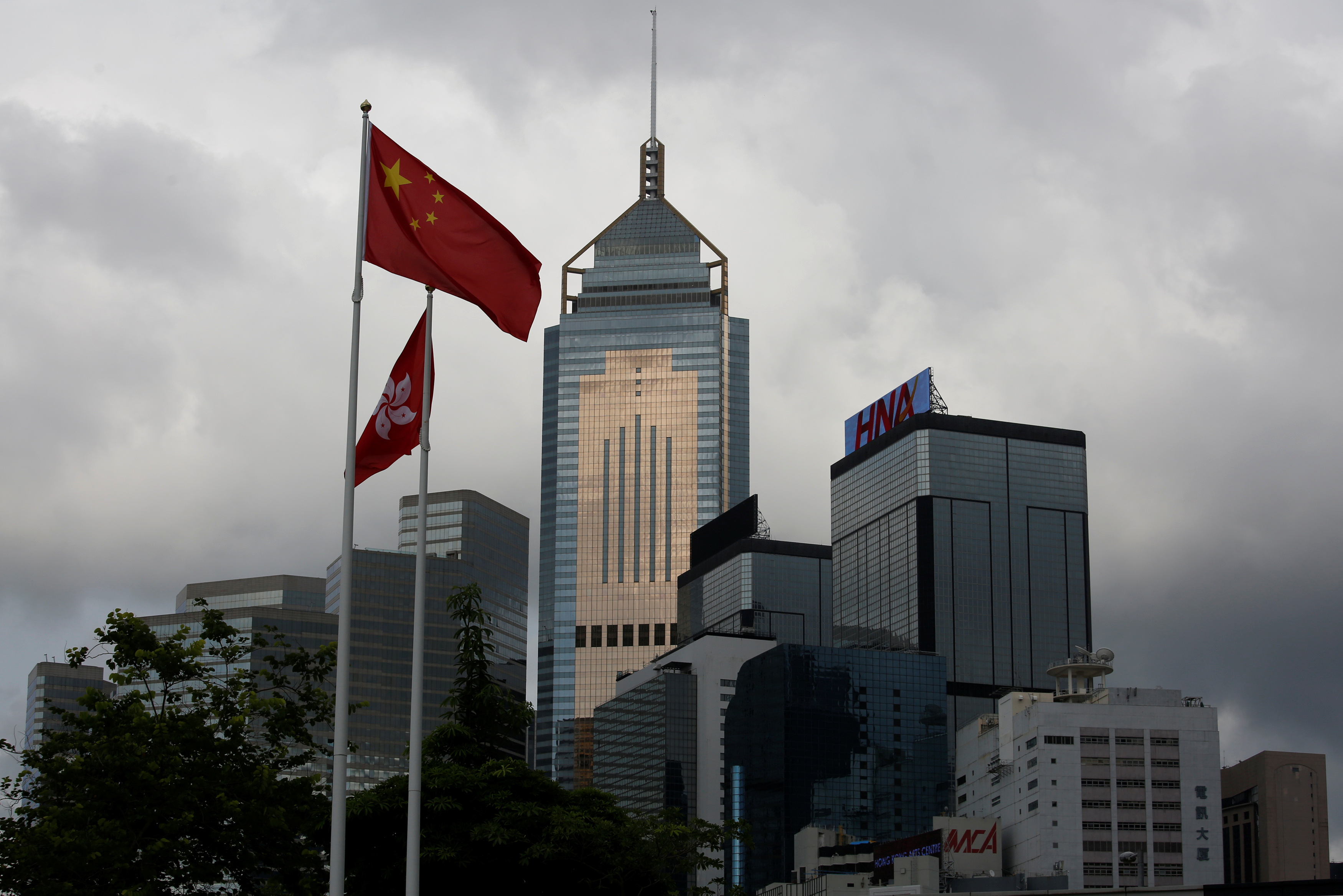 A Chinese national flag flies in front of commercial buildings in Hong Kong