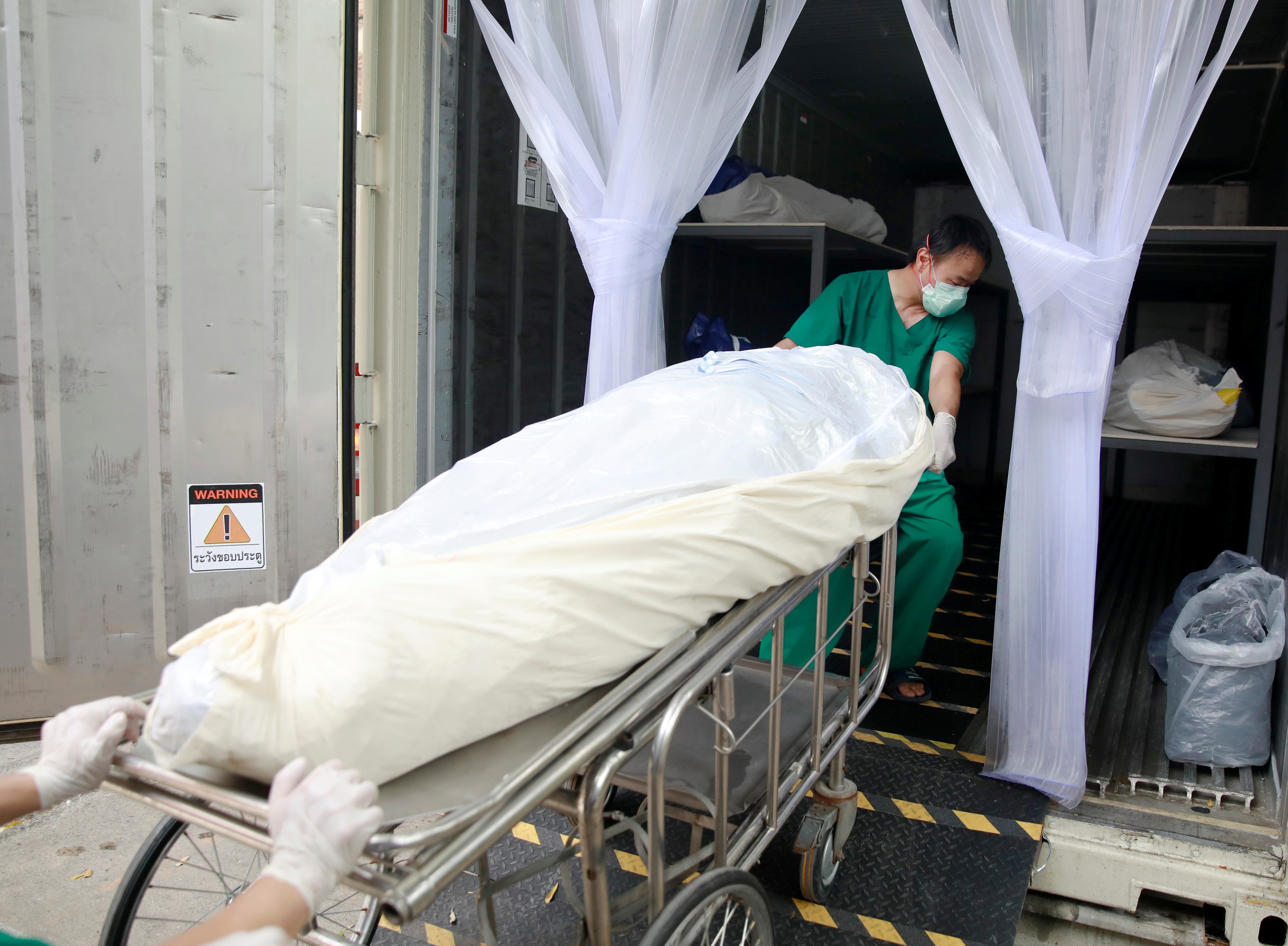 As cases surge, Thai hospital uses containers to store bodies