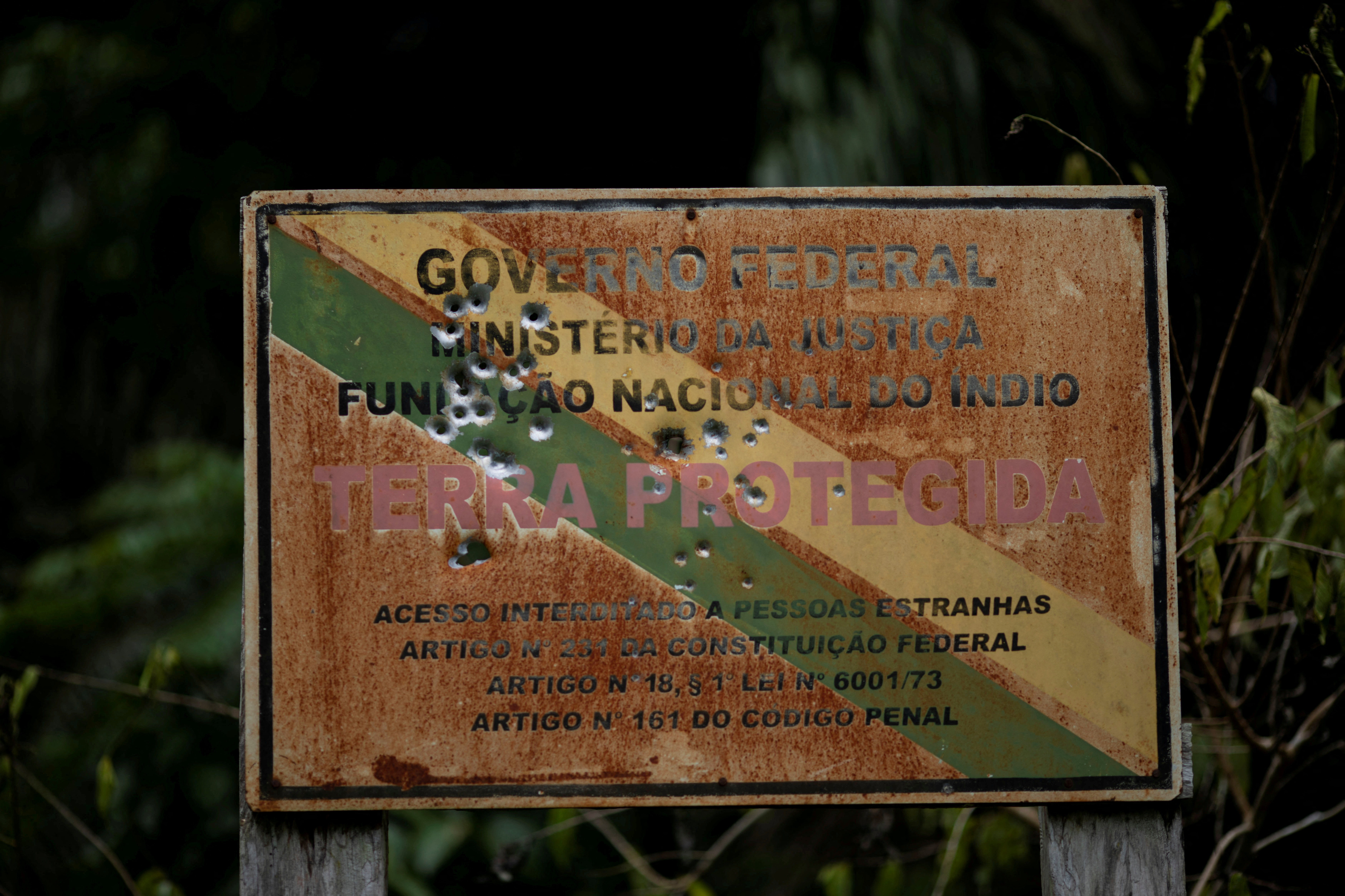 Shot marks are seen on an official Funai sign, which warns of the limits of the Uru-eu-wau-wau Indigenous Reservation near Campo Novo de Rondonia