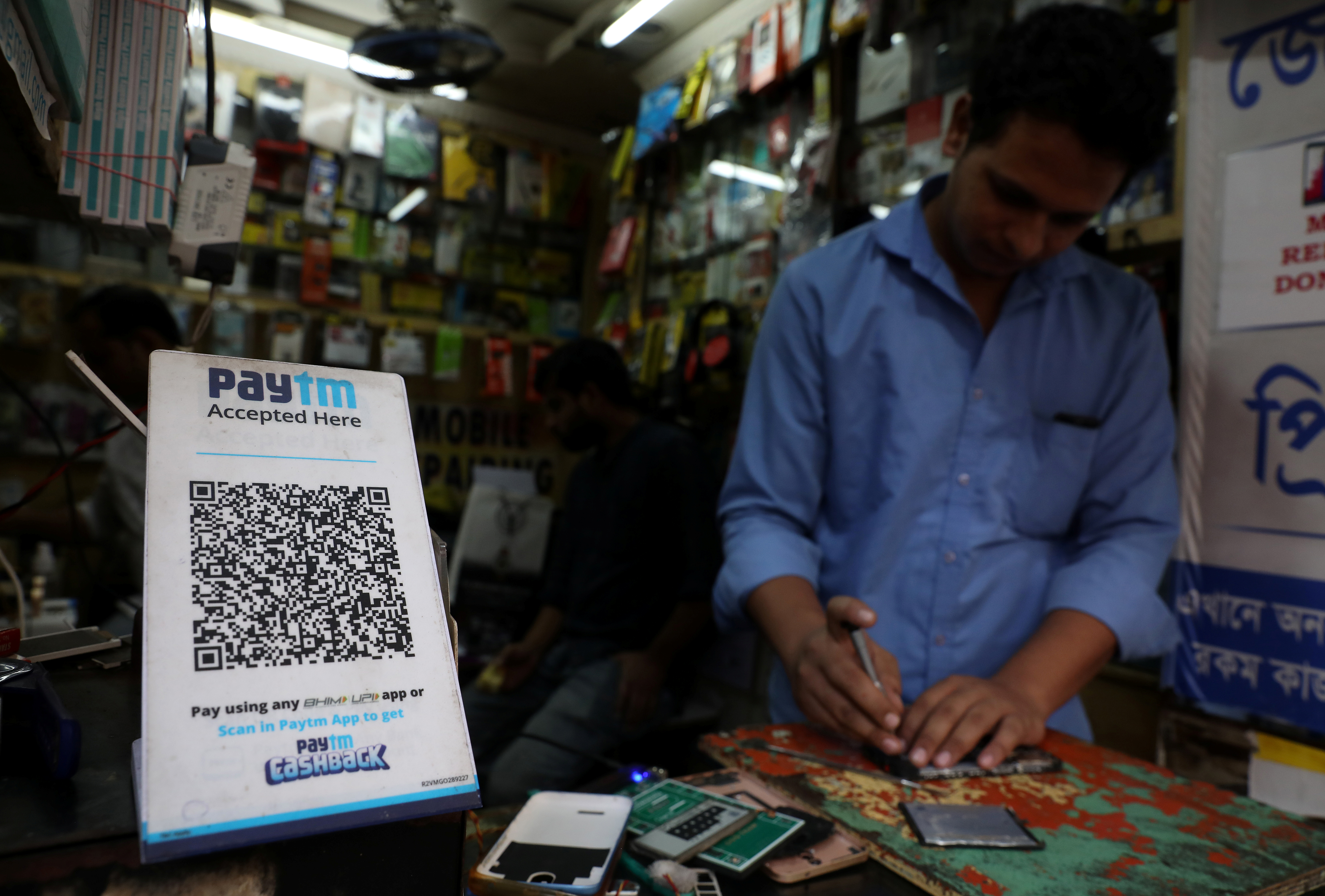 A QR code of Paytm is seen at a mobile repairing shop in Kolkata