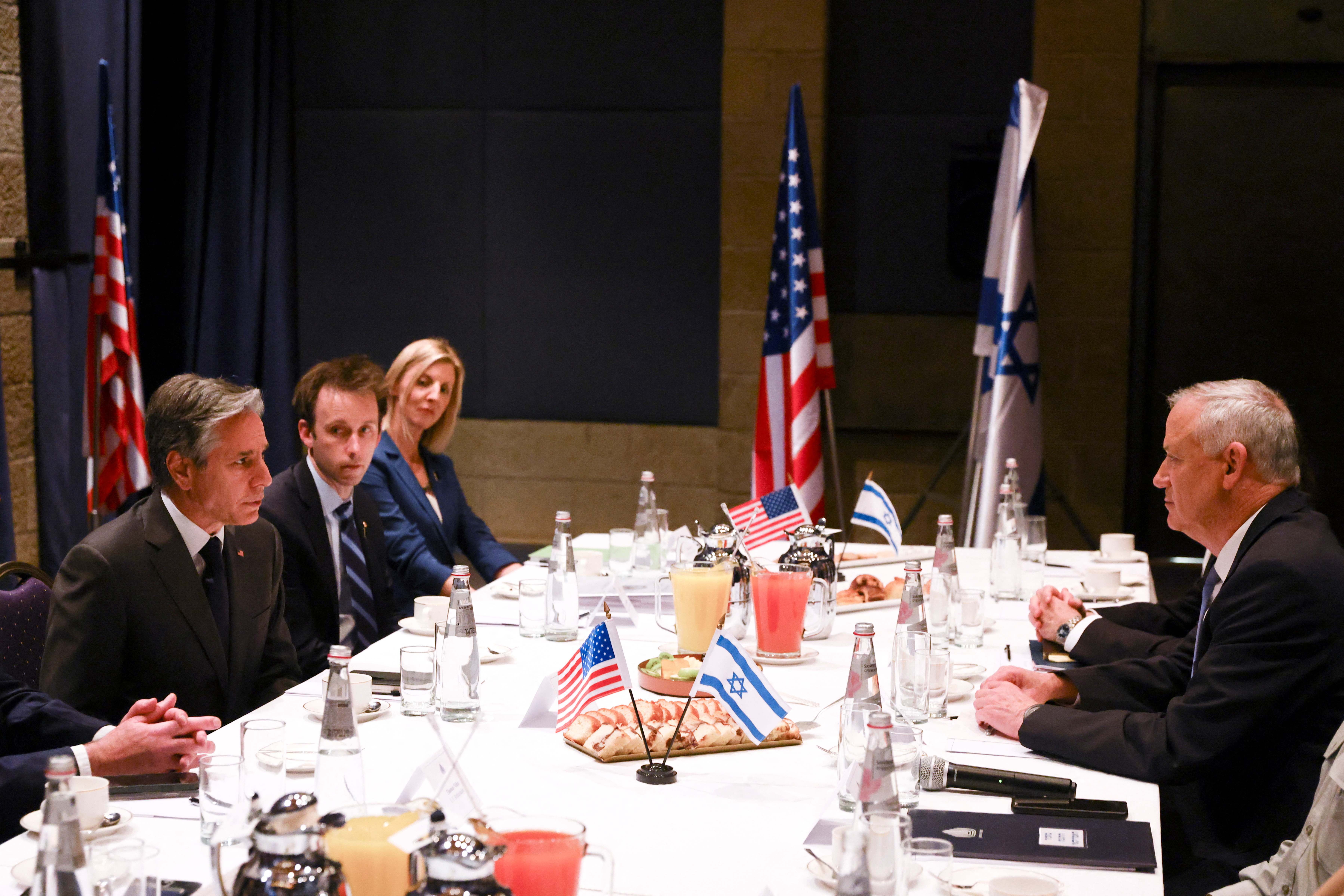 Israeli Defence Minister Benny Gantz sits across from U.S. Secretary of State Antony Blinken during a diplomatic meeting, at the David Citadel Hotel in Jerusalem