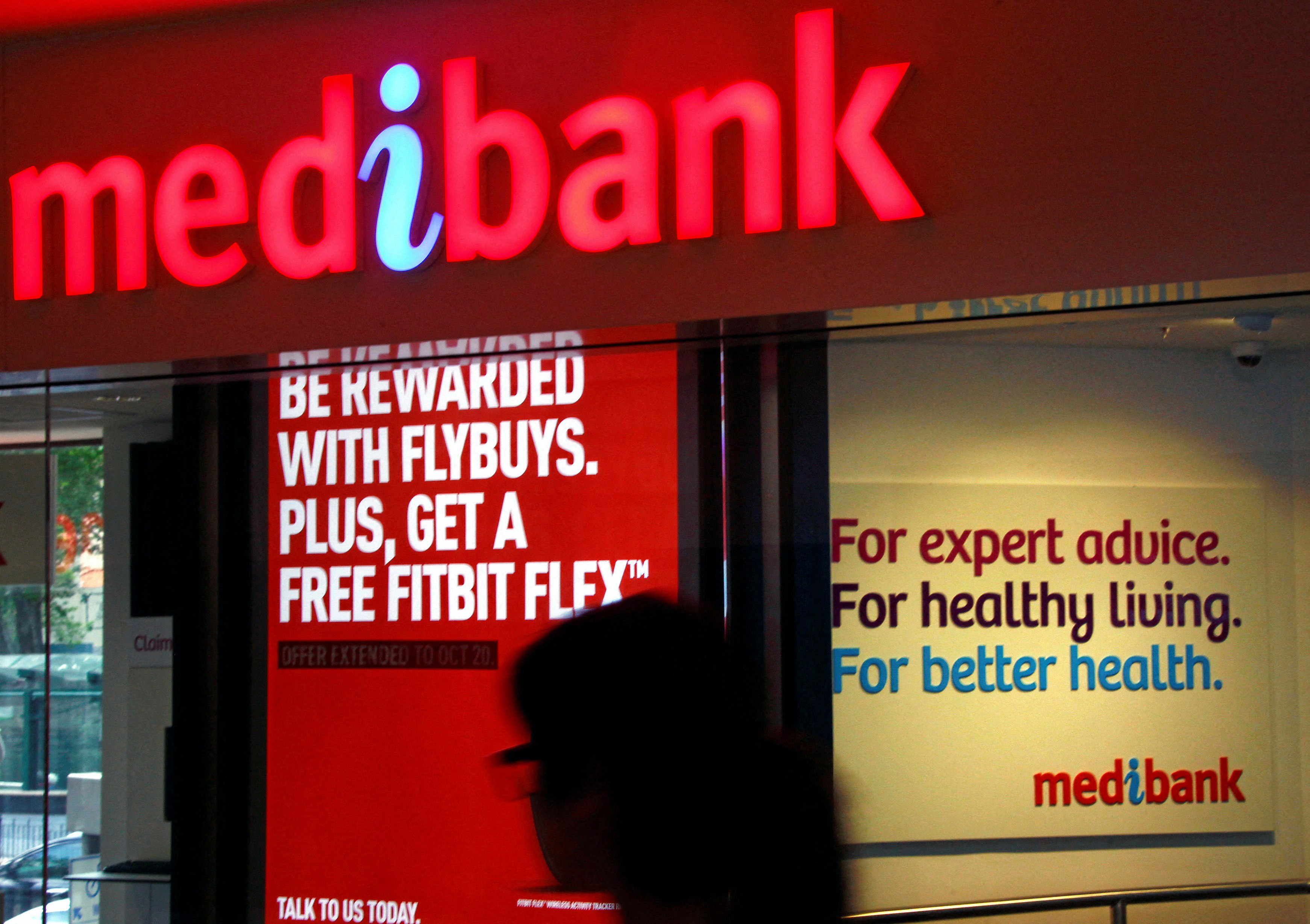 A woman walks past a branch of the Australian health insurer Medibank Private in Sydne