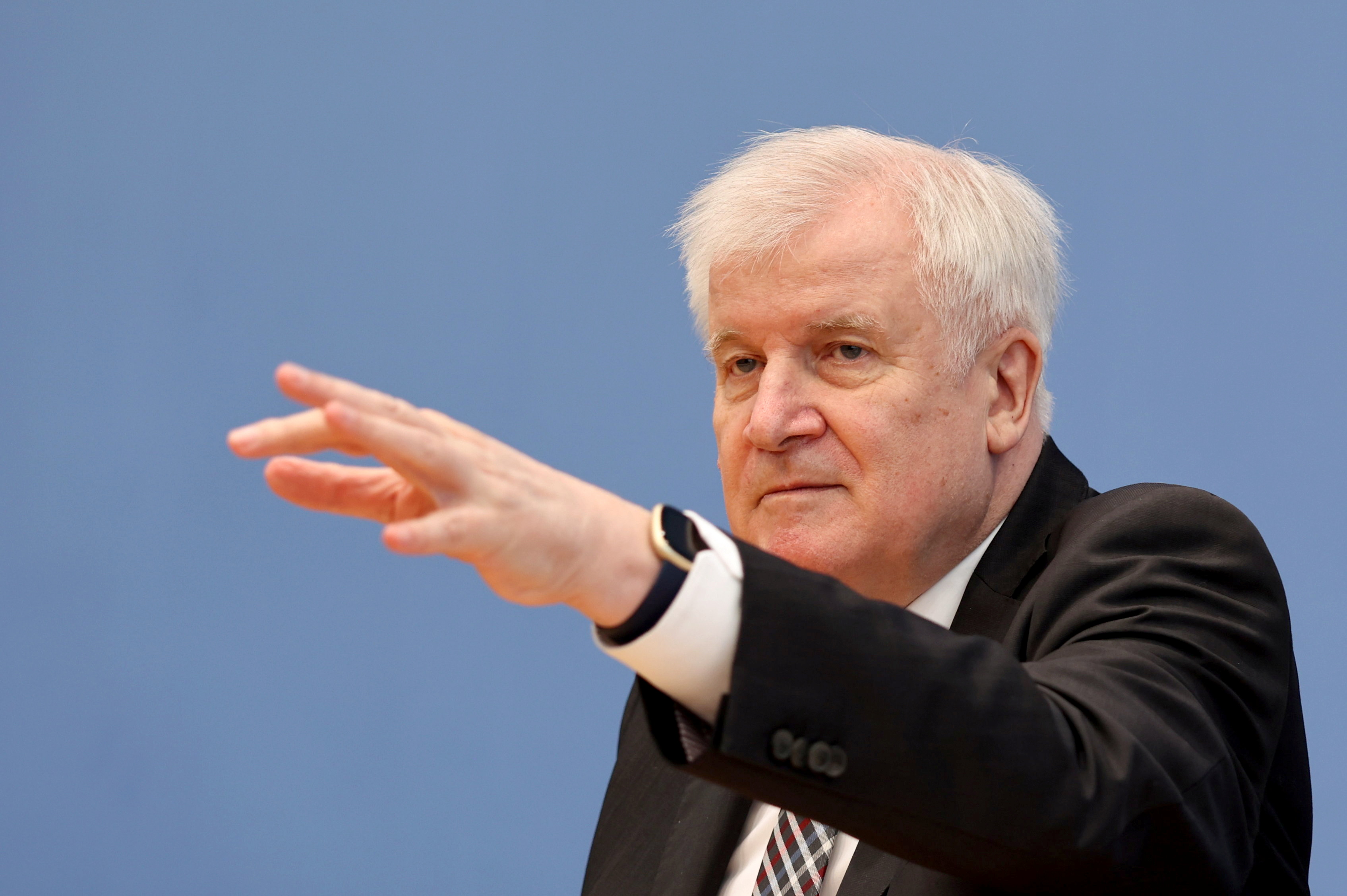 Germany's Interior Minister Horst Seehofer gestures as he attends a news conference on migration, in Berlin, Germany, October 20, 2021. REUTERS/Christian Mang/Pool
