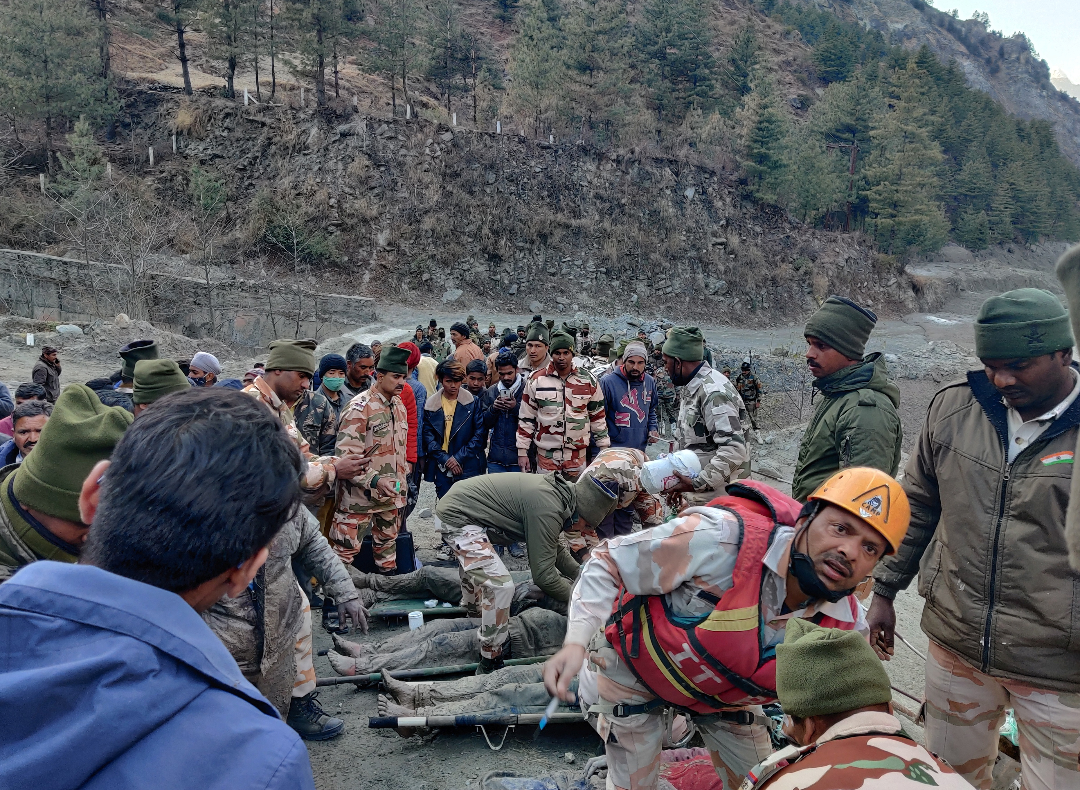 Members of Indo-Tibetan Border Police tend to people rescued after a Himalayan glacier broke and swept away a small hydroelectric dam, in Chormi
