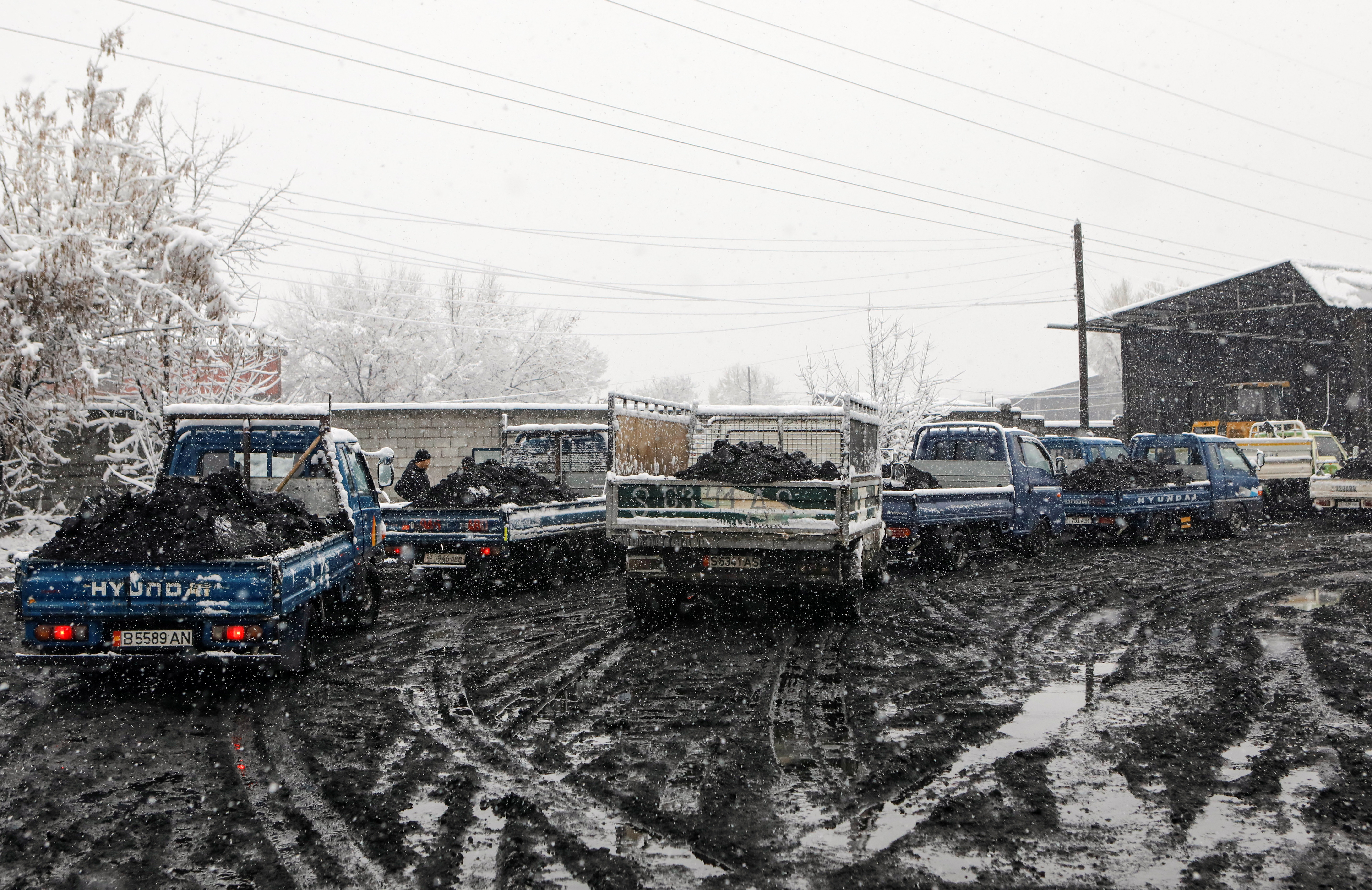 Lorries are seen in a queue for coal that people buy at reduced prices to heat their homes amid the energy crunch, in Bishkek, Kyrgyzstan November 26, 2021.  REUTERS/Vladimir Pirogov