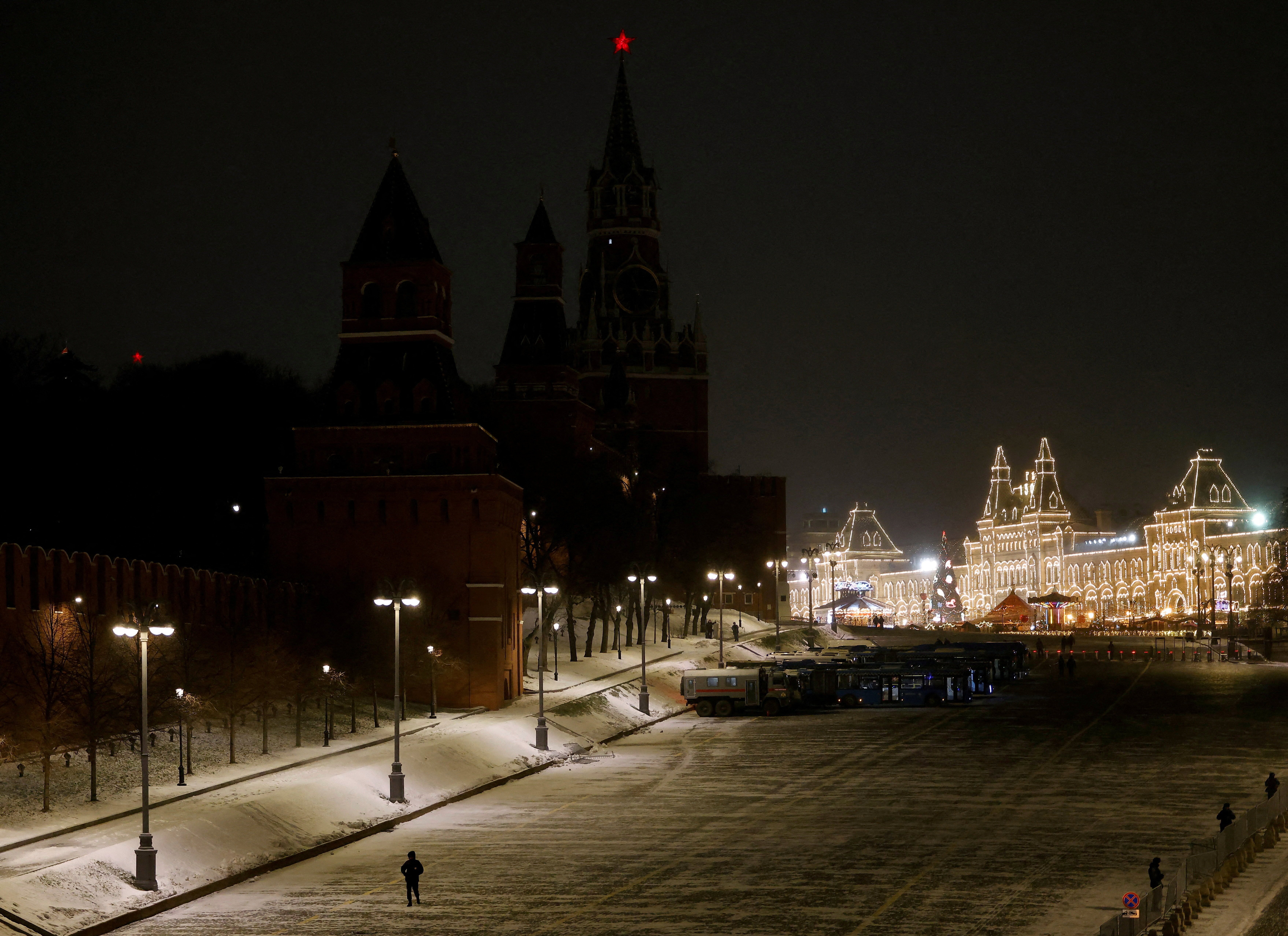 A law enforcement officer walks along the Kremlin wall during New Year's Eve celebrations in Moscow