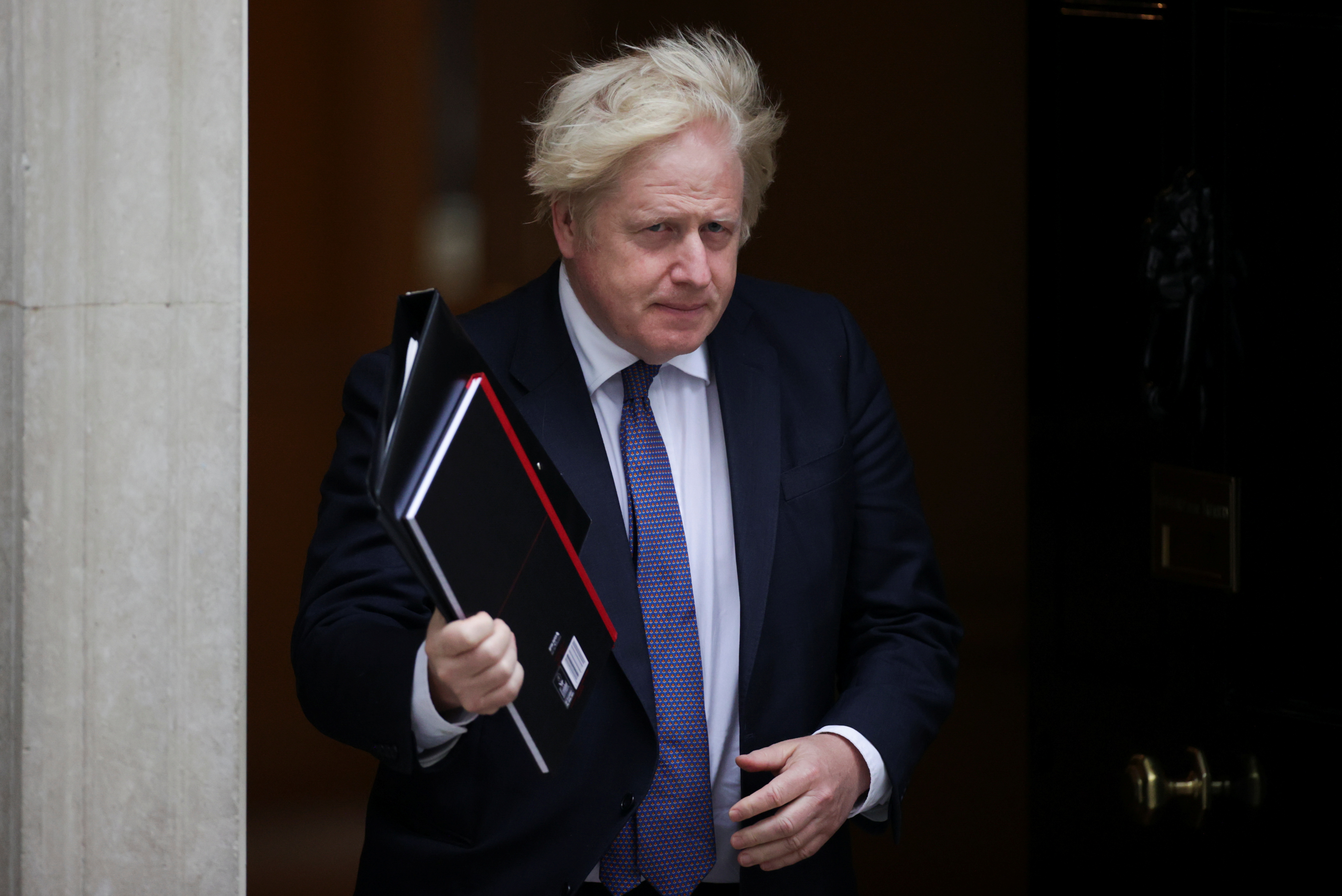 Britain's PM Boris Johnson walks outside Downing Street in London