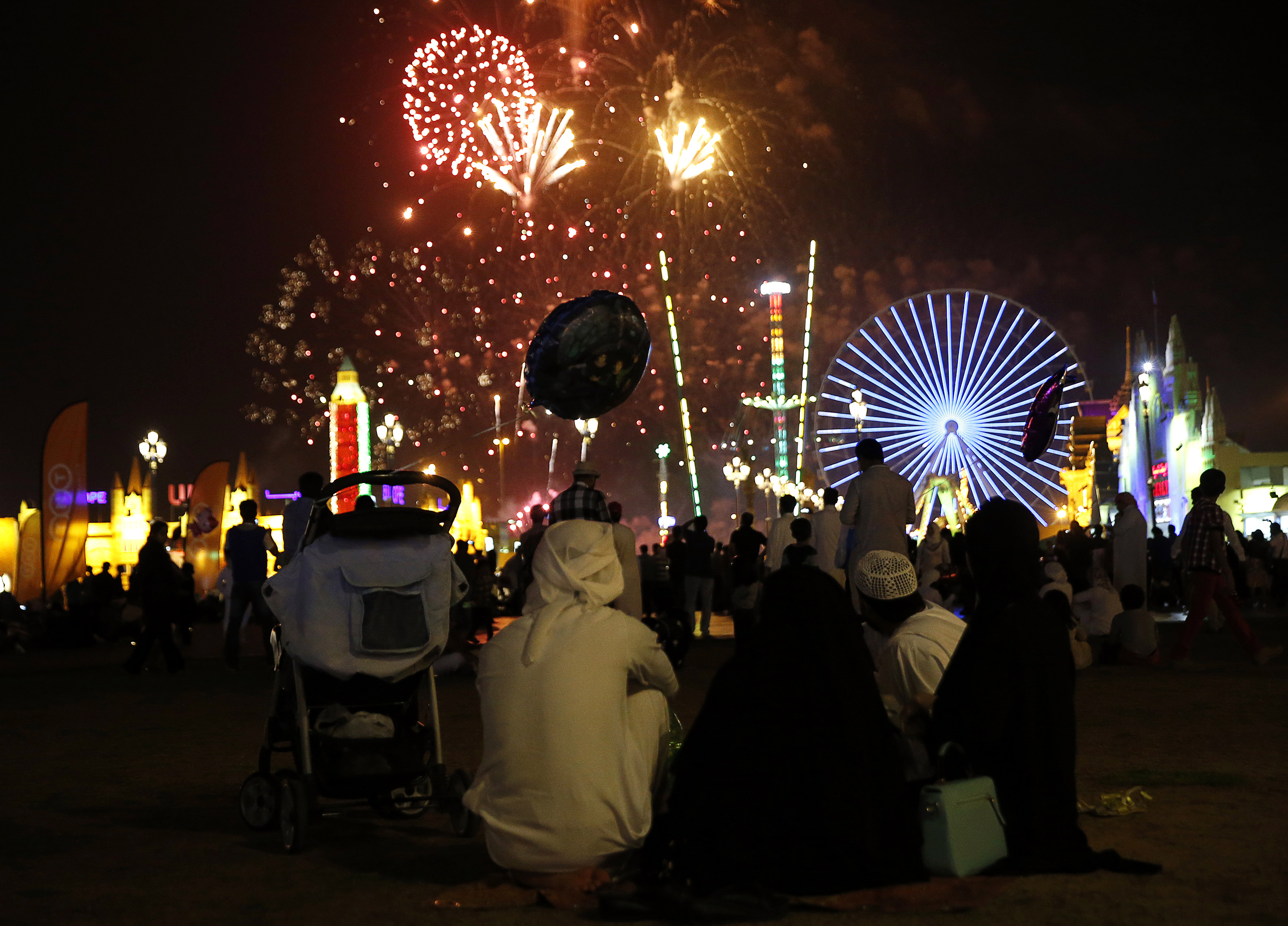 An Emirati family watches the fireworks display at the Global Village in Dubai