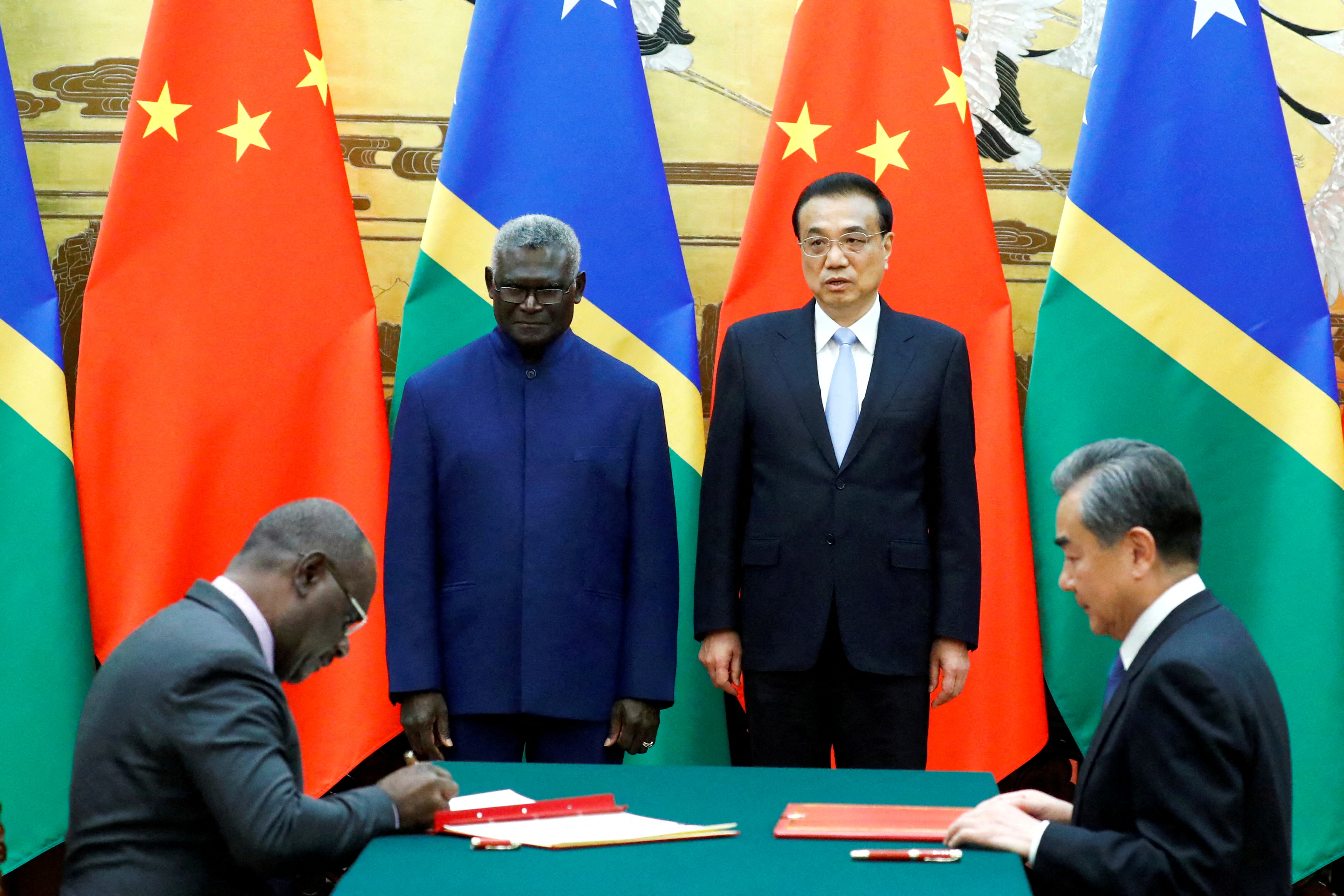 Solomon Islands Prime Minister Manasseh Sogavare, Solomon Islands Foreign Minister Jeremiah Manele, Chinese Premier Li Keqiang and Chinese State Councillor and Foreign Minister Wang Yi attend a signing ceremony at the Great Hall of the People i
