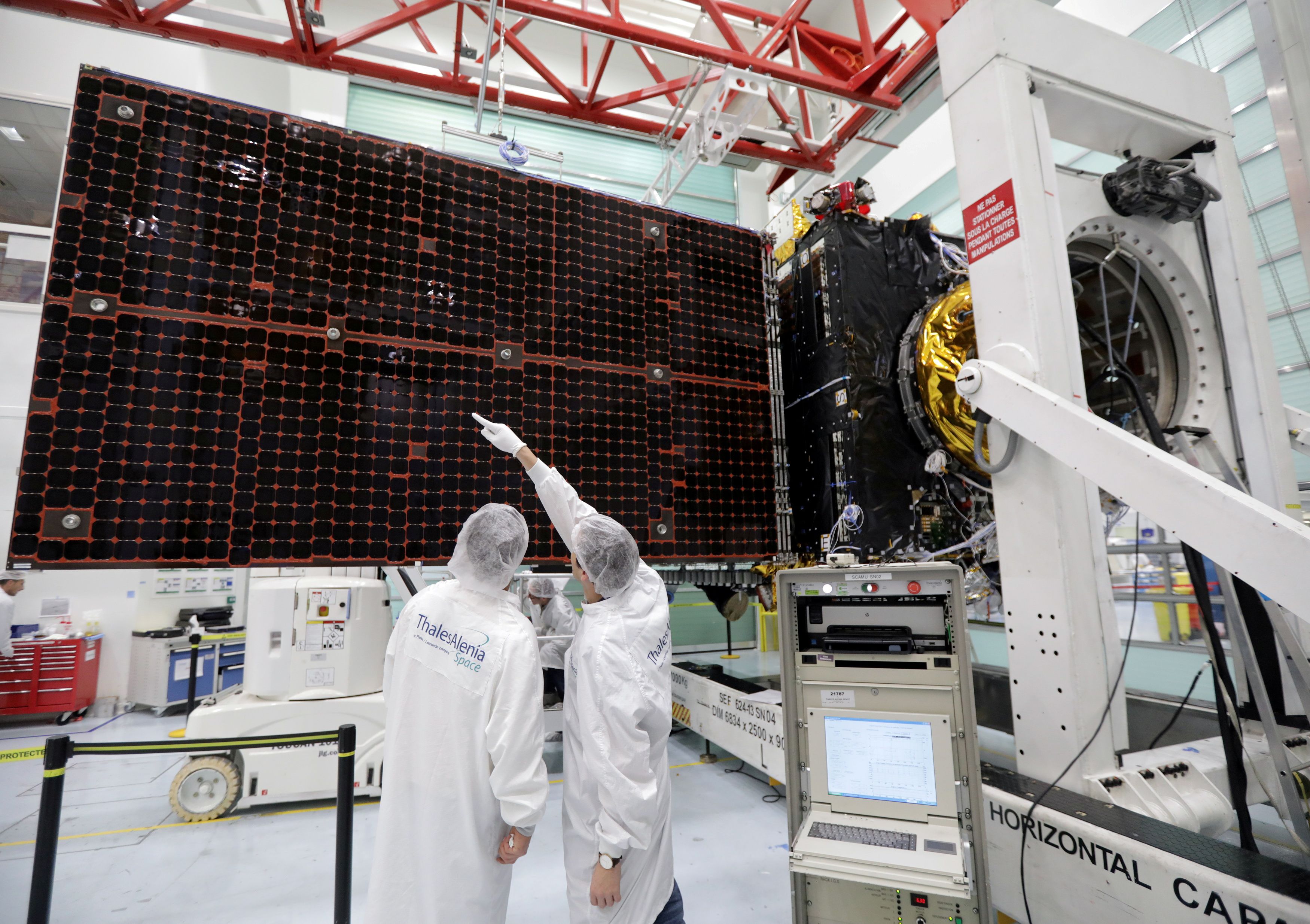 A technician looks at a solar panel on the Inmarsat S-Band/Hellas-Sat 3 satellite in the clean room facilities of the Thales Alenia Space plant in Cannes, France, February 3, 2017.   REUTERS/Eric Gaillard
