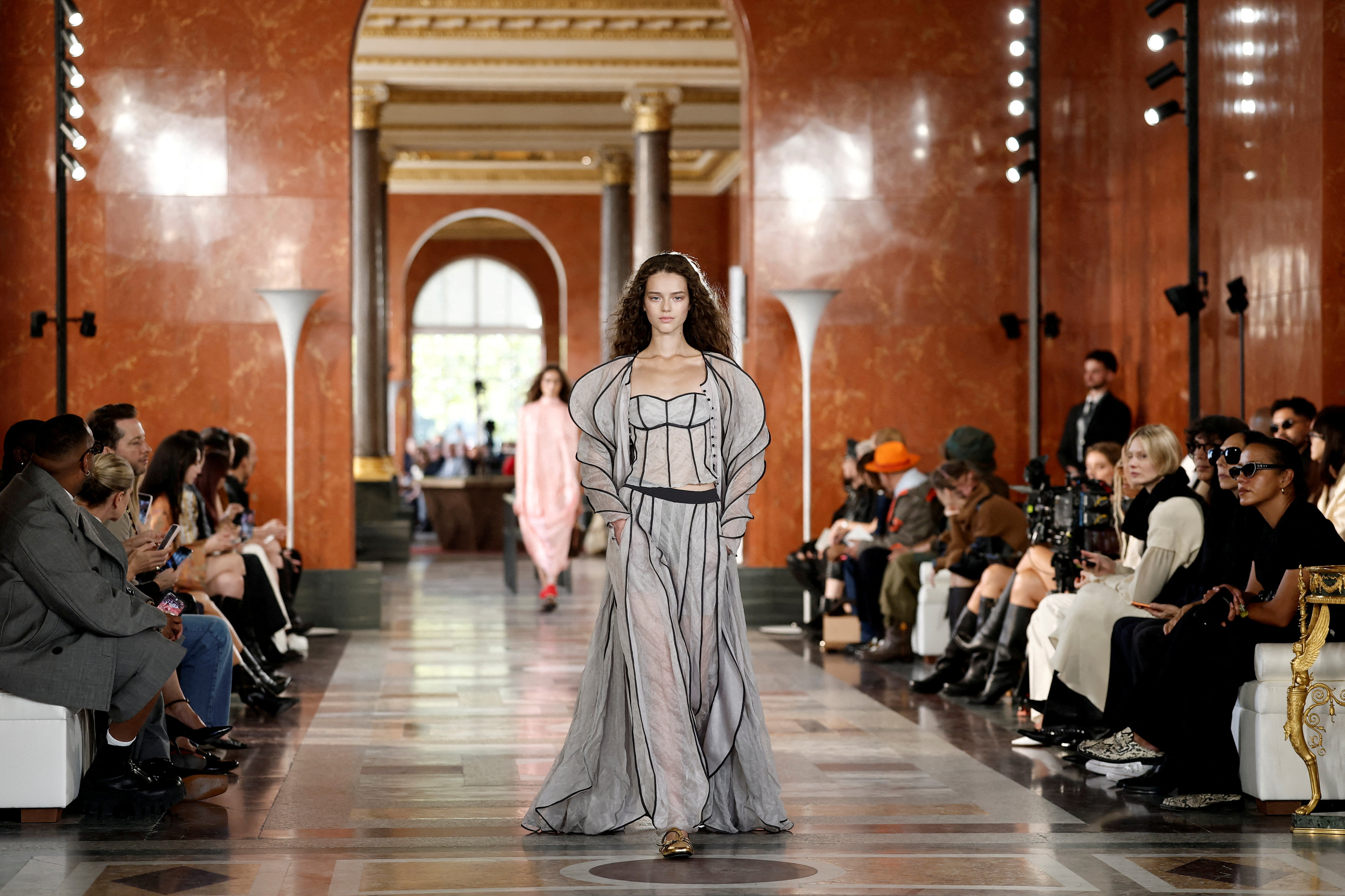 Louis Vuitton shows soft knitwear on Louvre catwalk | Reuters
