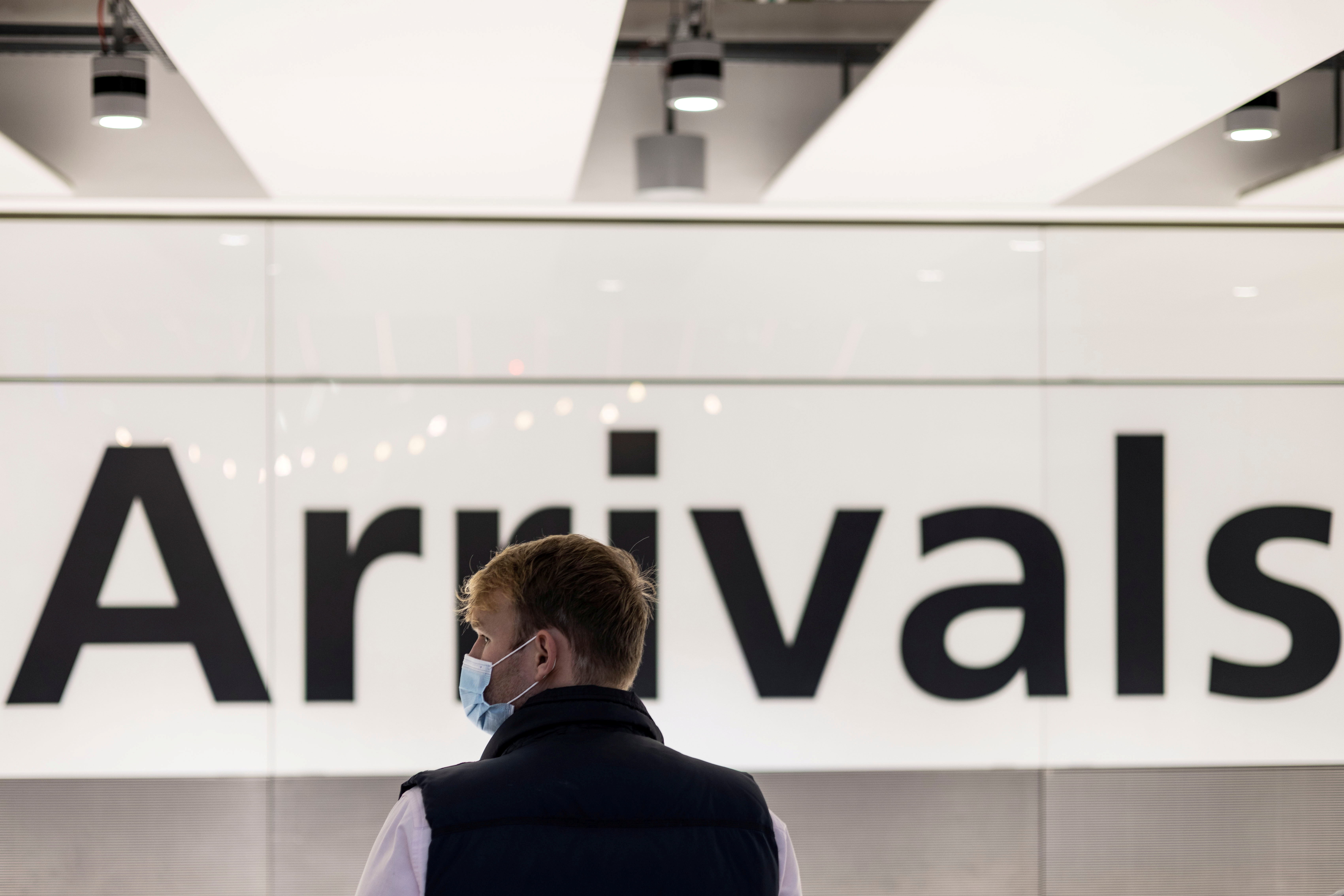 A man is seen waiting at the arrival area of terminal 5 following the lifting of restrictions on the entry of non-U.S. citizens imposed to help curb the spread of the coronavirus disease (COVID-19), at Heathrow International airport, in London, Britain November 8, 2021. 