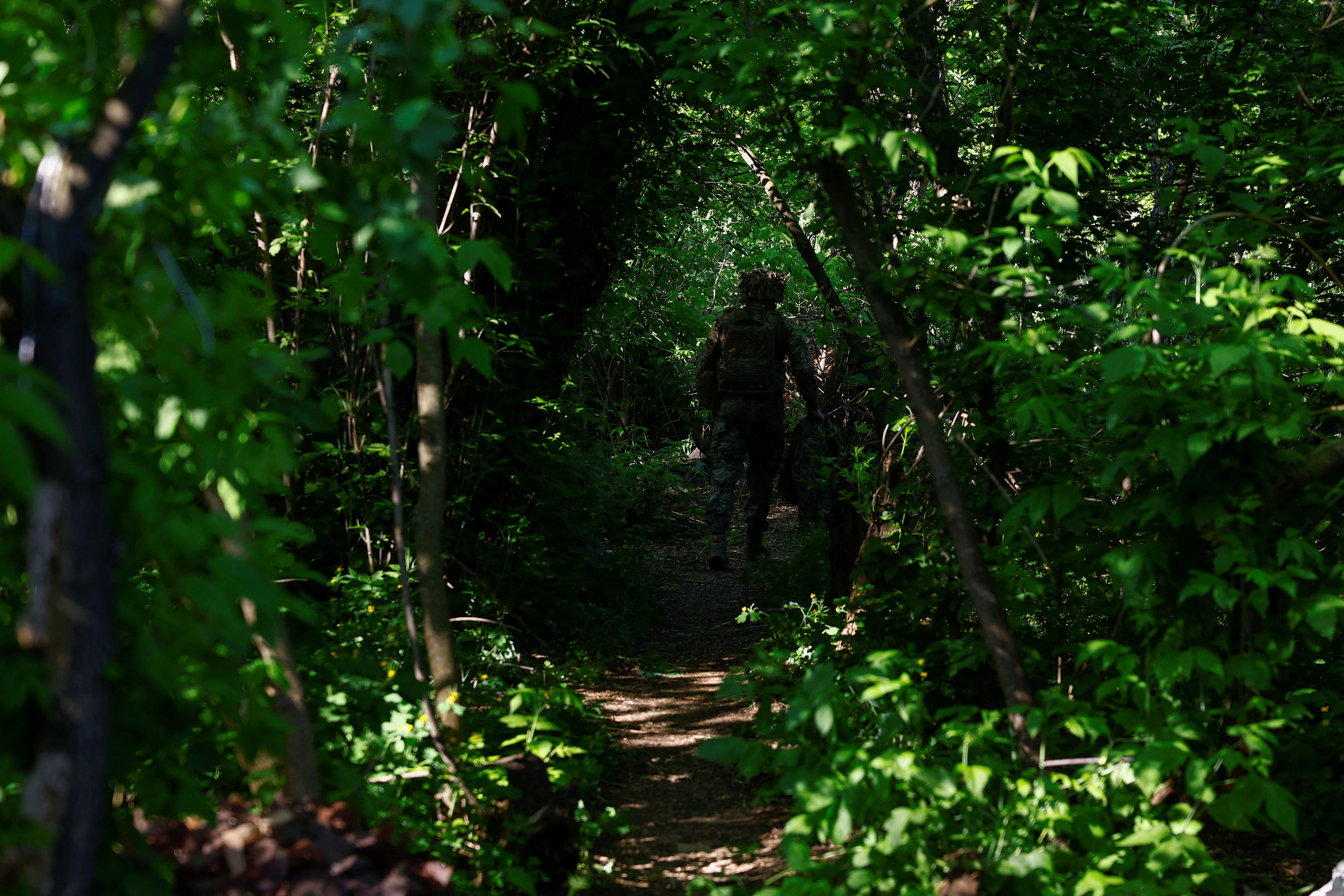 walks at a position after firing a howitzer toward Russian troops near a front line in Donetsk region