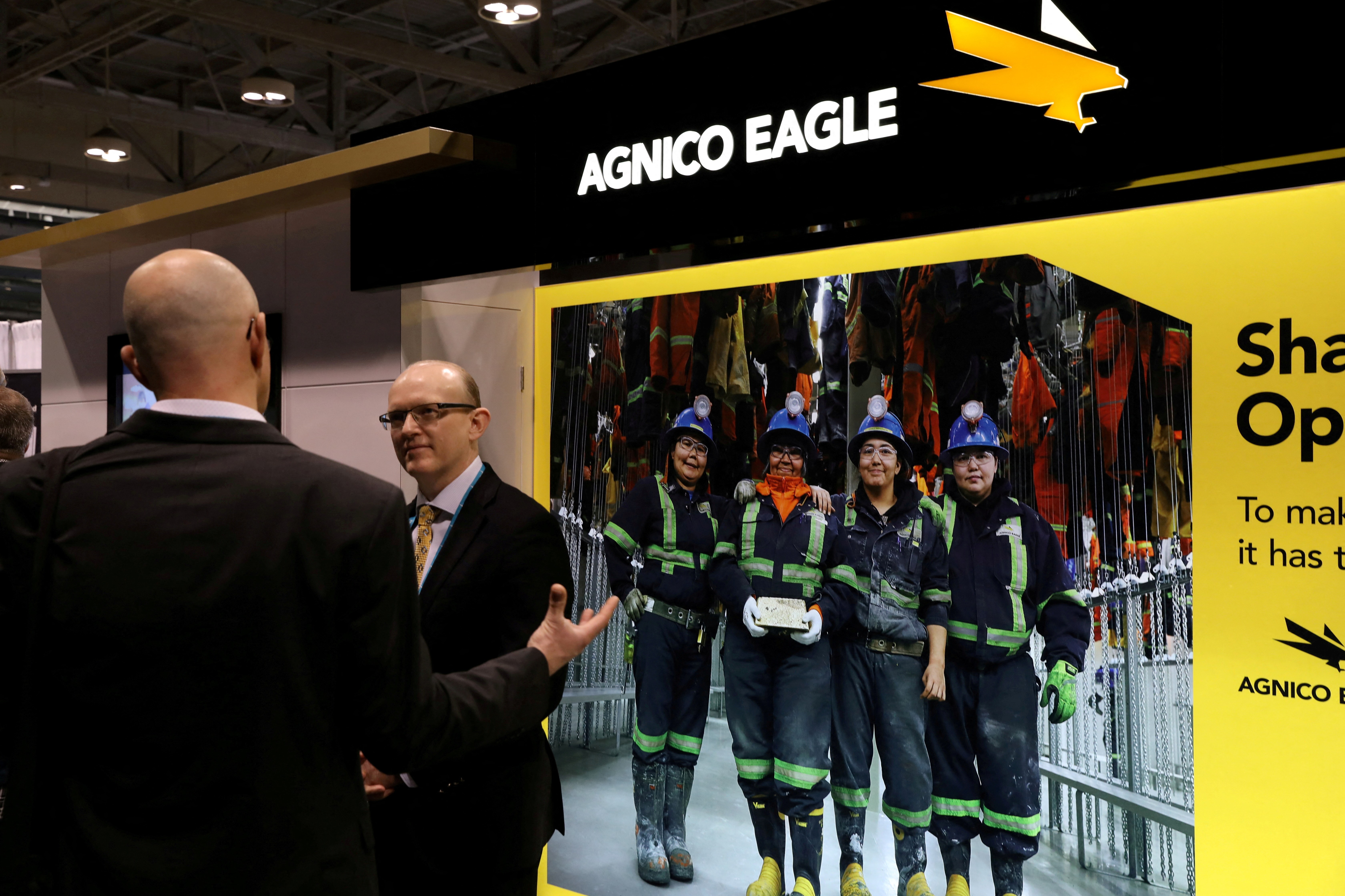 A visitor speaks to a representative of Agnico Eagle Mines at the PDAC annual conference in Toronto