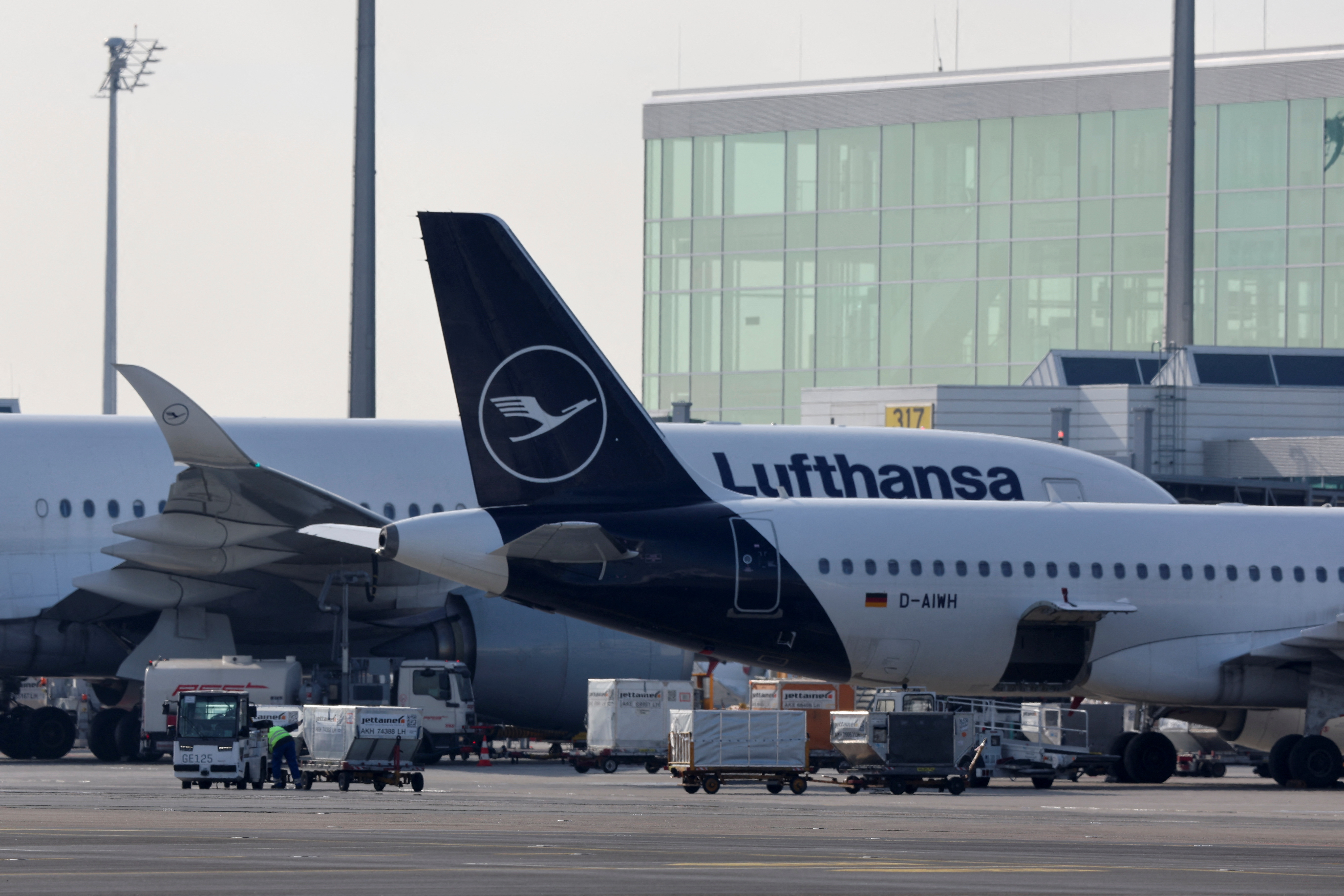 Lufthansa's aircrafts are seen on the tarmac at the Munich International Airport