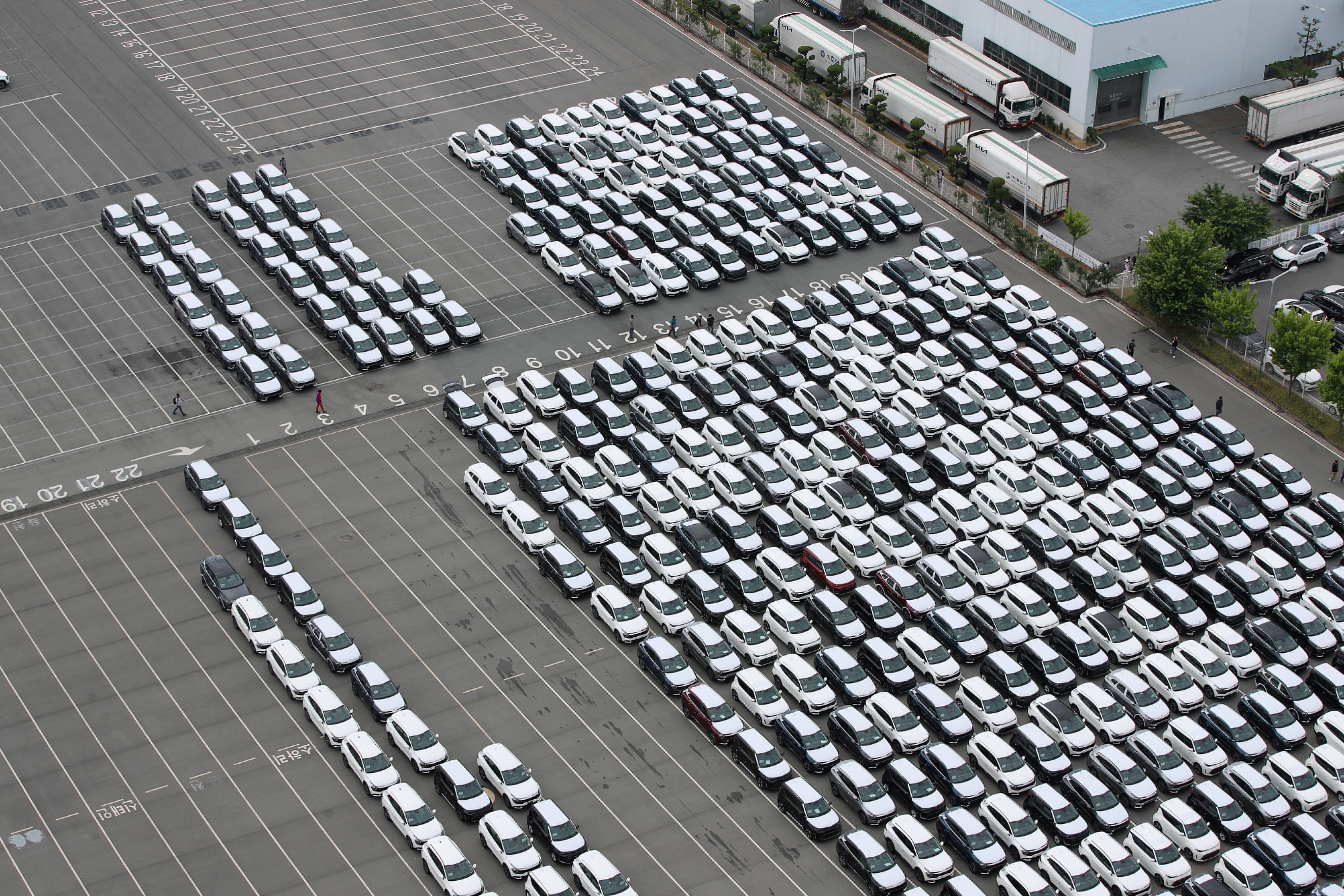 A general view of Kia Motor's finished cars parked and waiting to be transported by car carriers which are now on strike at their factory, in Gwangju