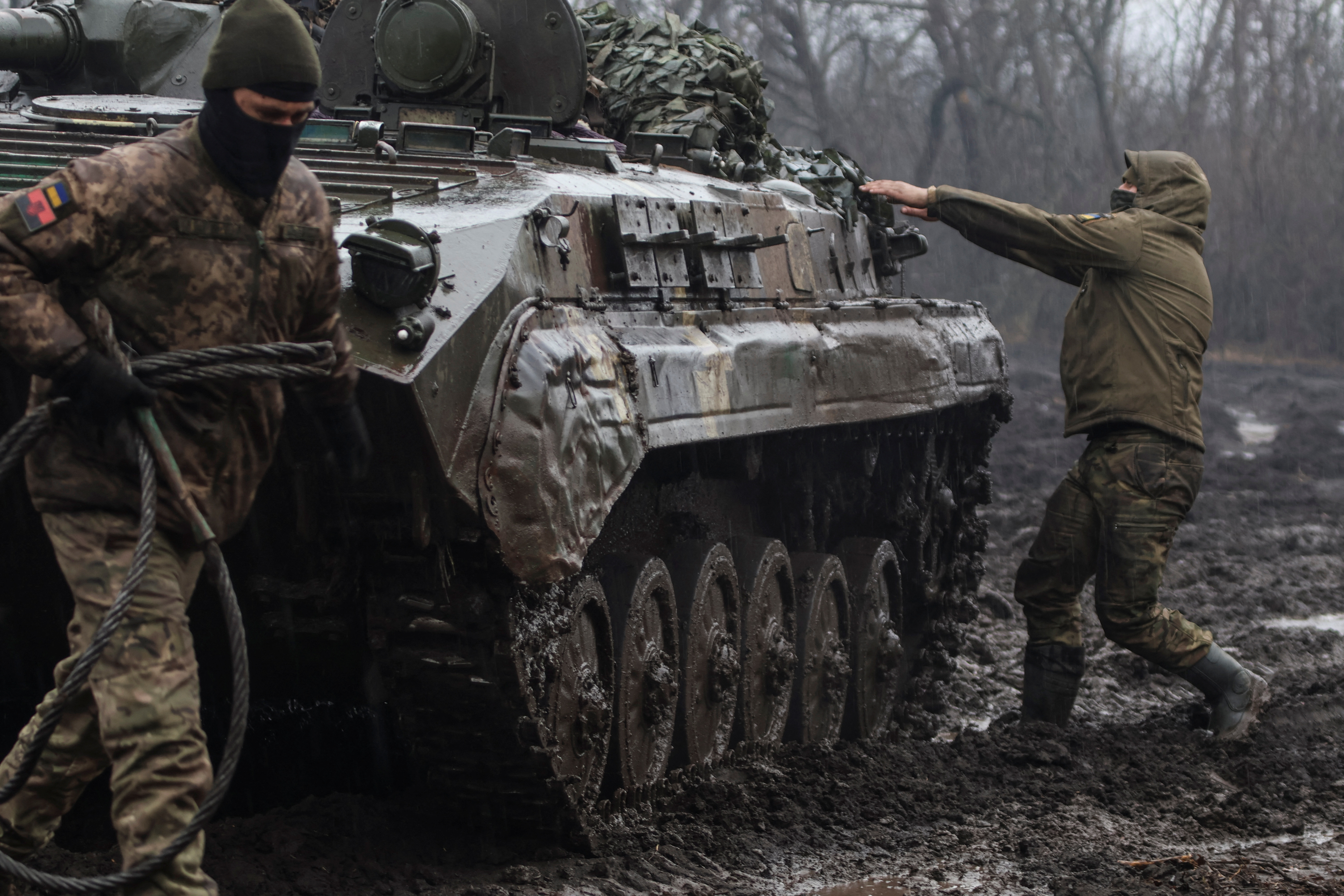 Ukrainian service members are seen next an infantry fighting vehicle near the frontline town of Bakhmut