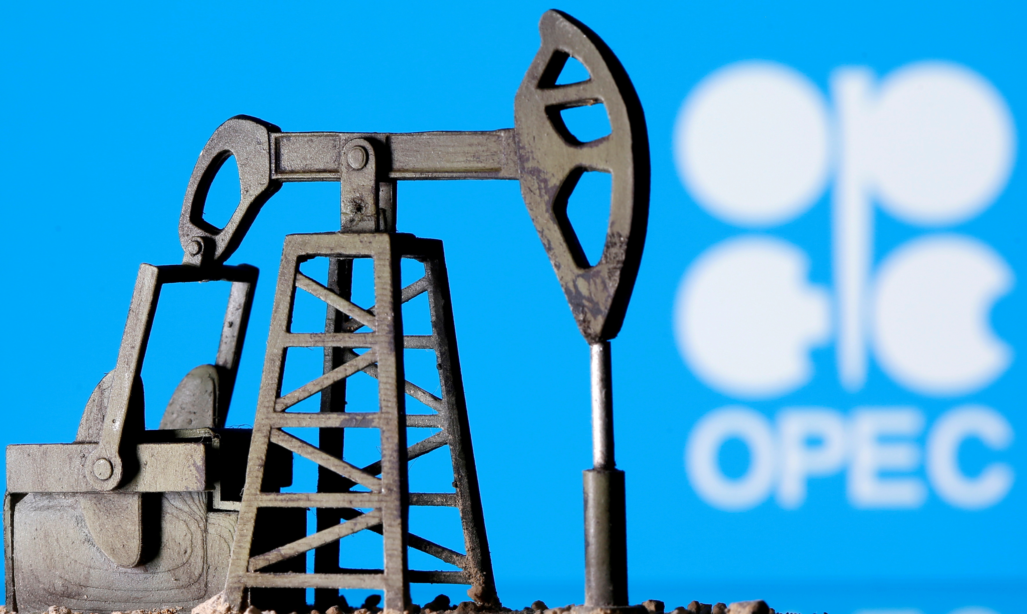 A 3D printed oil pump jack is seen in front of displayed OPEC logo in this illustration picture