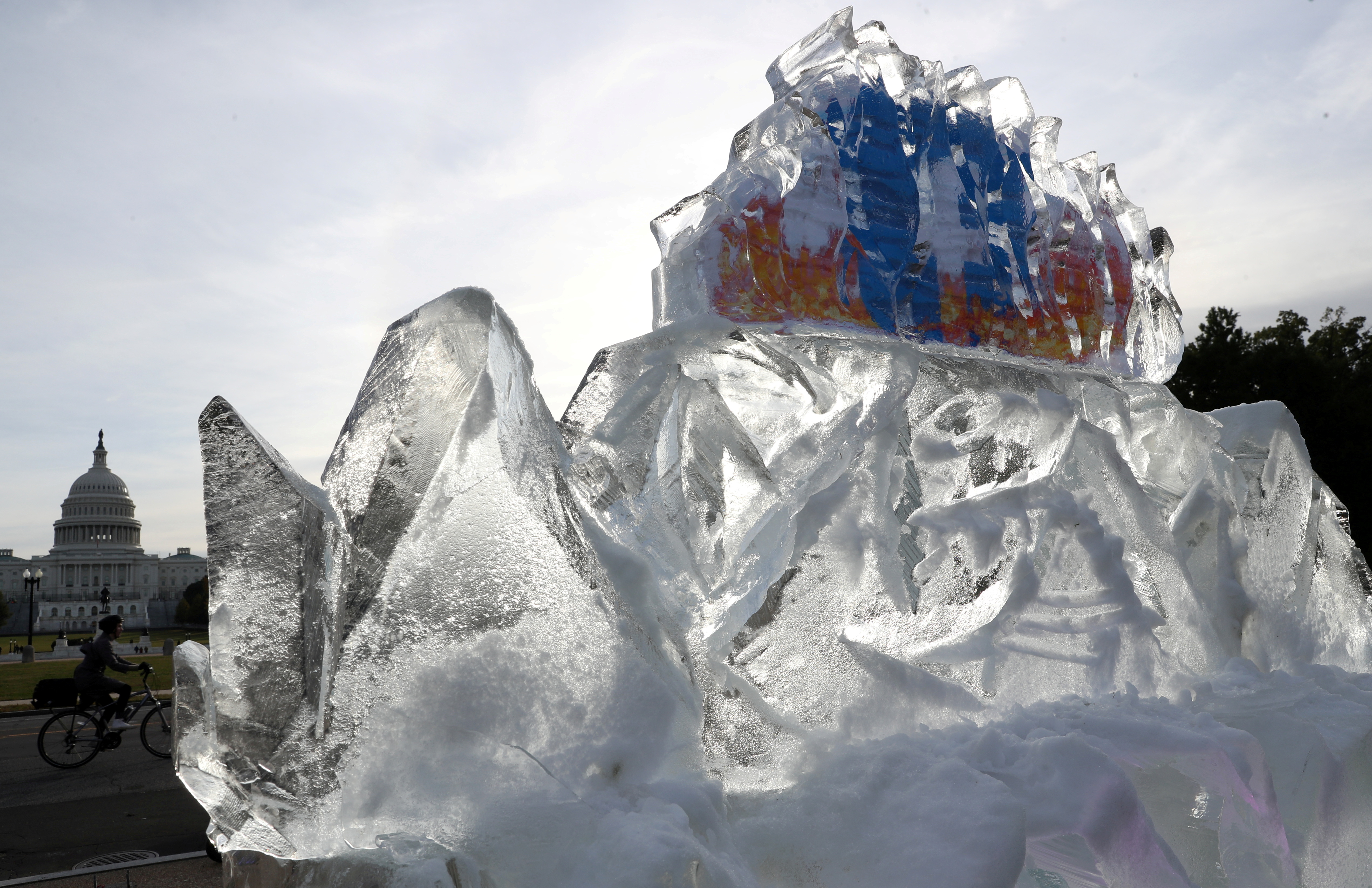 A 5,000 pound ice sculpture with Facebook’s logo embedded on the inside, placed on the National Mall by climate activists, melts near the U.S. Capitol building to protest what they say is Facebook’s role in promoting climate misinformation online in Washington, U.S., November 4, 2021. REUTERS/Leah Millis/File Photo/File Photo