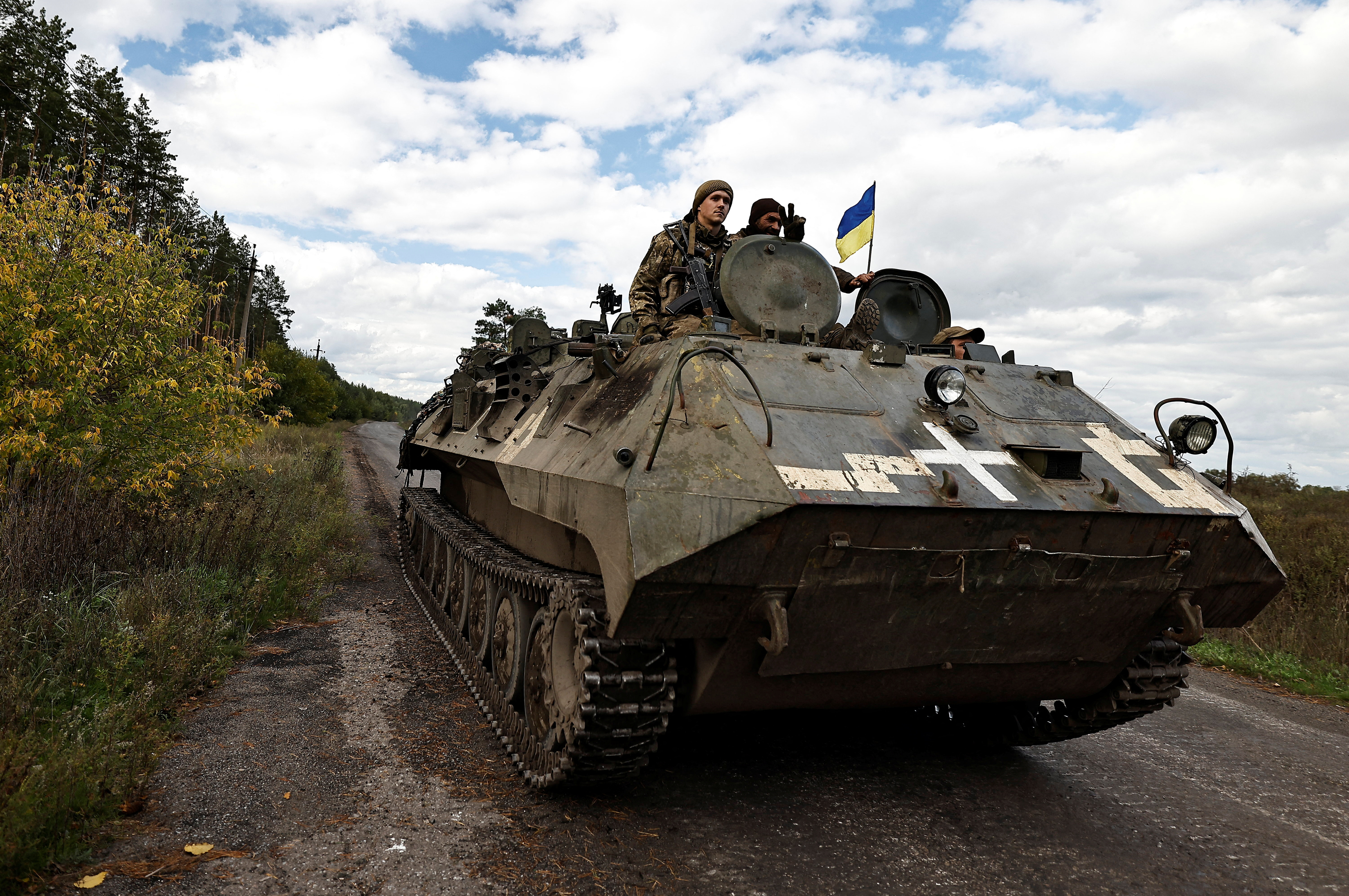 Ukrainians ride an armoured vehicle in Donesk region