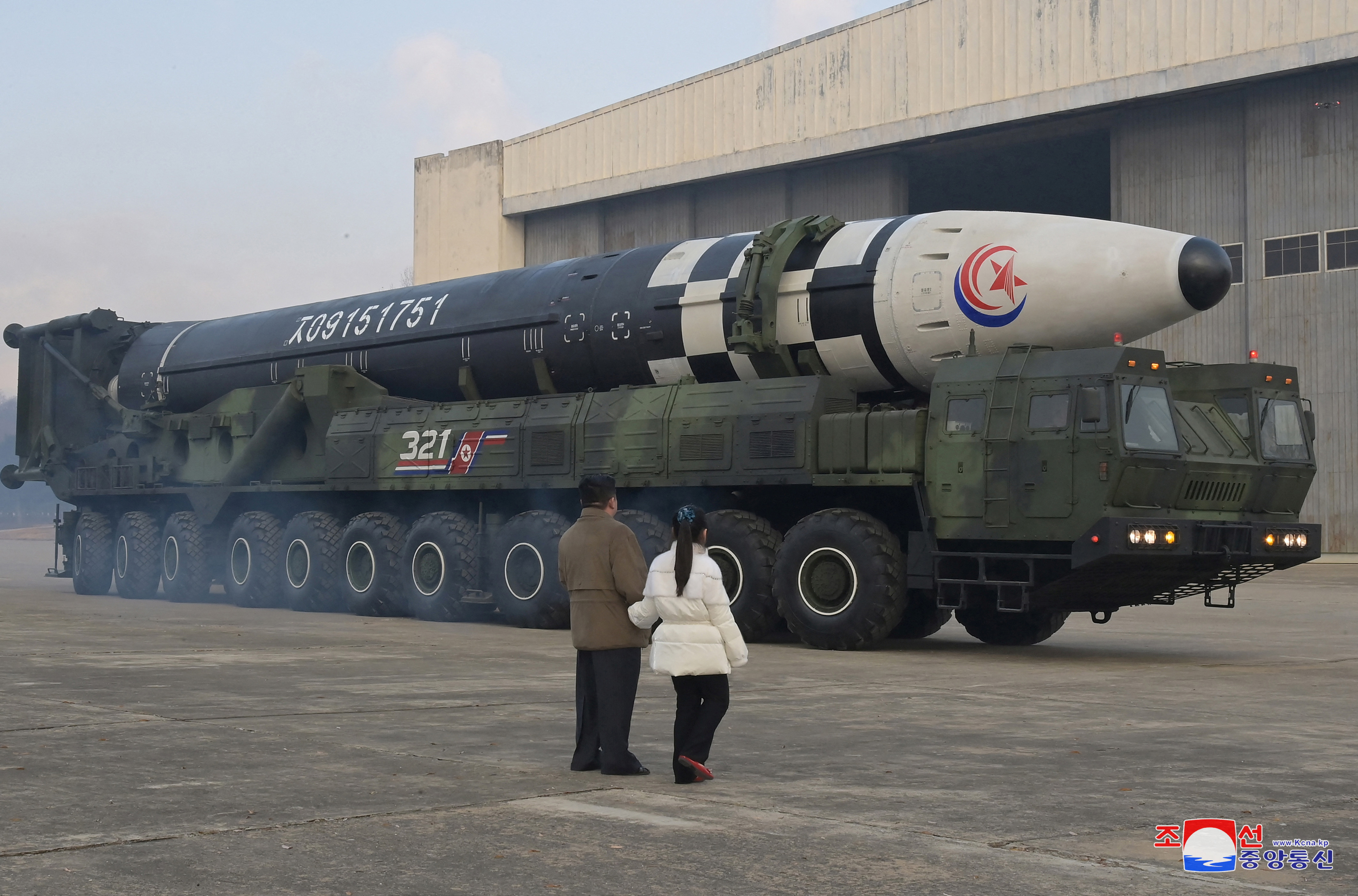 North Korean leader Kim Jong Un, along with his daughter, inspects an ICBM in this undated photo released by KCNA