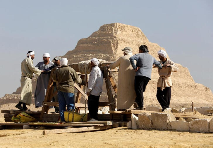 People work at the site after the announcement of the discovery of 4,300-year-old sealed tombs in Egypt's Saqqara necropolis, in Giza