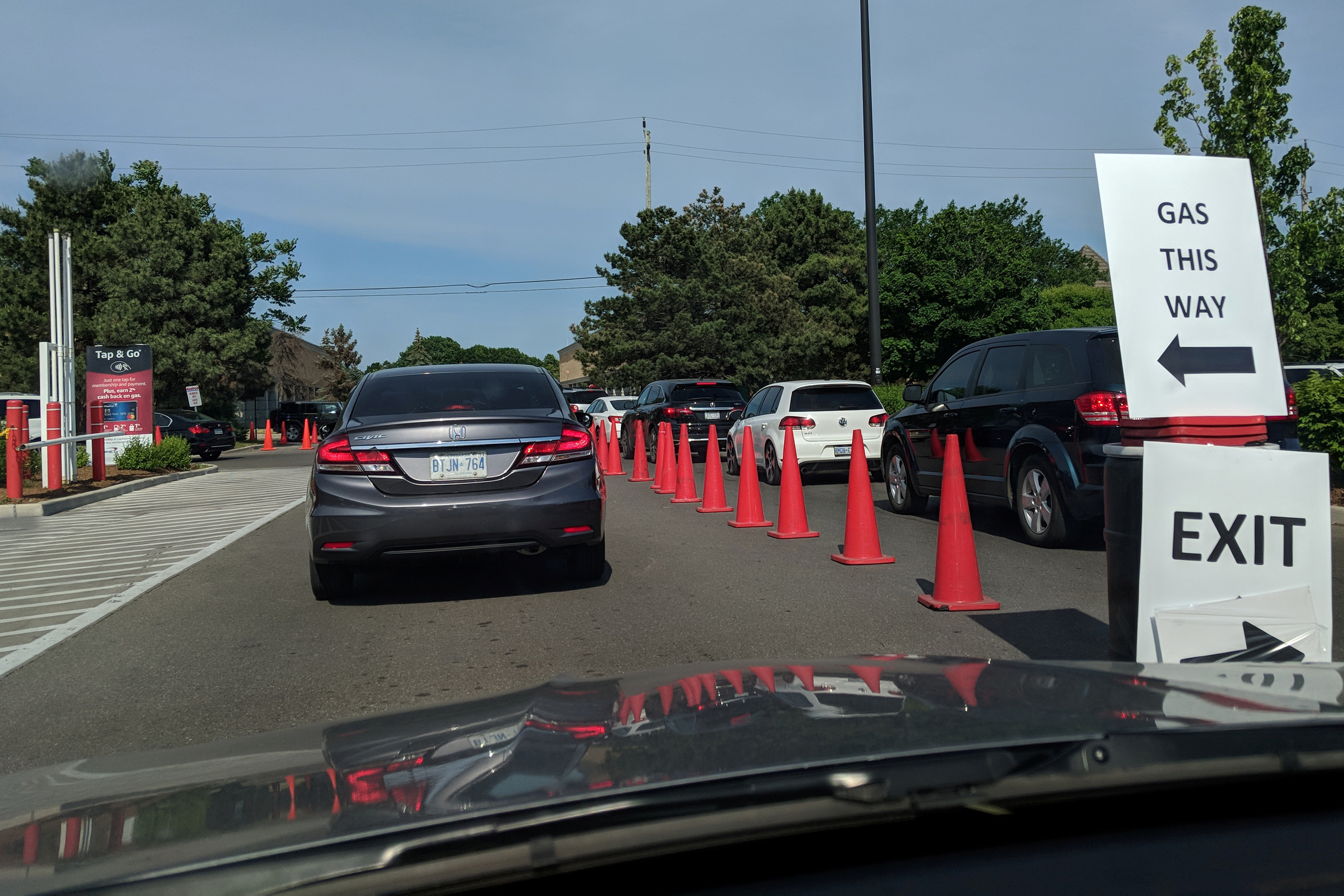 Traffic cones are placed to guide cars lining up for gasoline at Costco in Toronto