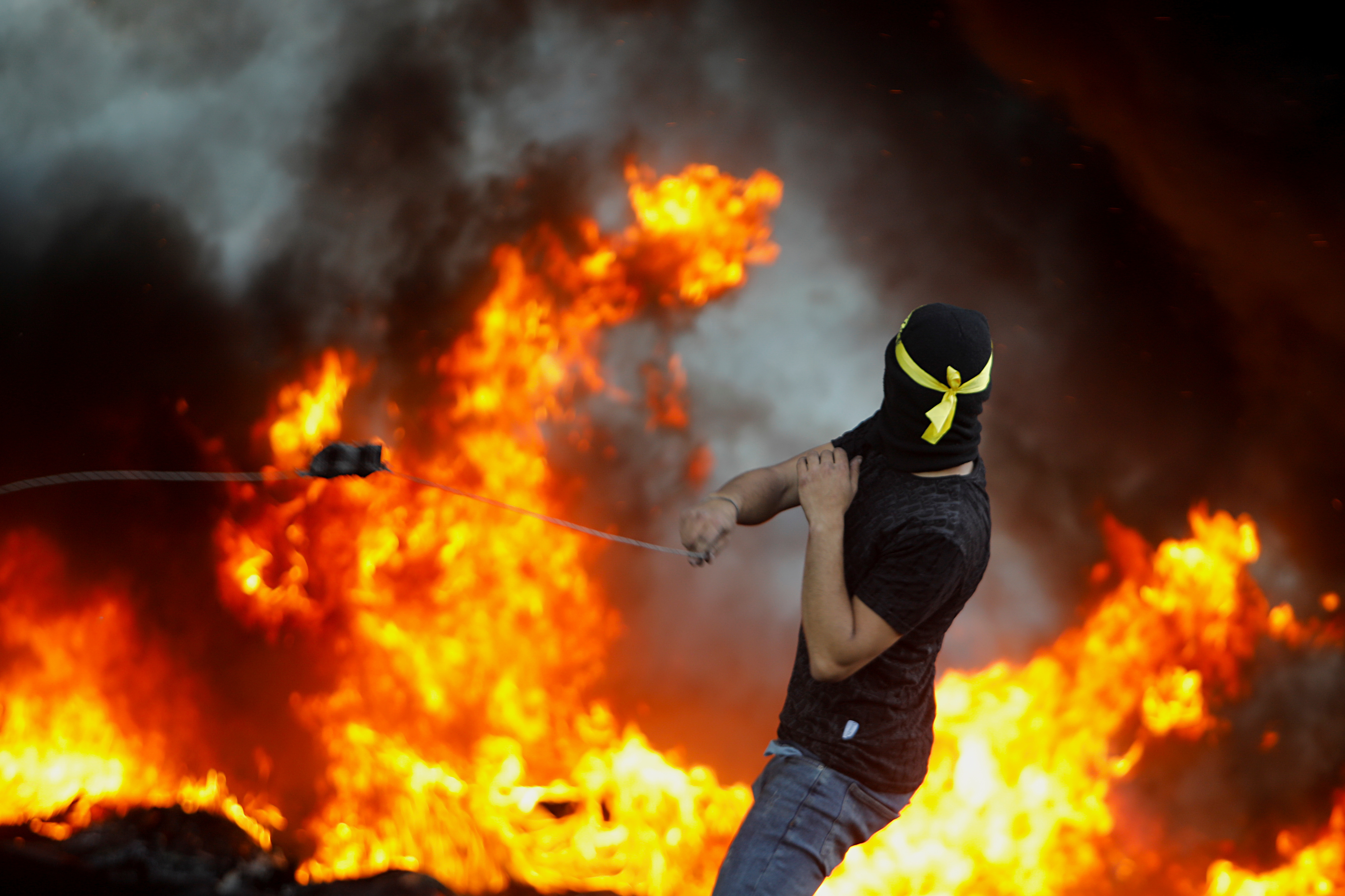 A Palestinian demonstrator takes part in an anti-Israel protest over a cross-border violence between Palestinian militants in Gaza and the Israeli military, near Hawara checkpoint near Nablus in the Israeli-occupied West Bank, May 18, 2021. REUTERS/Raneen Sawafta