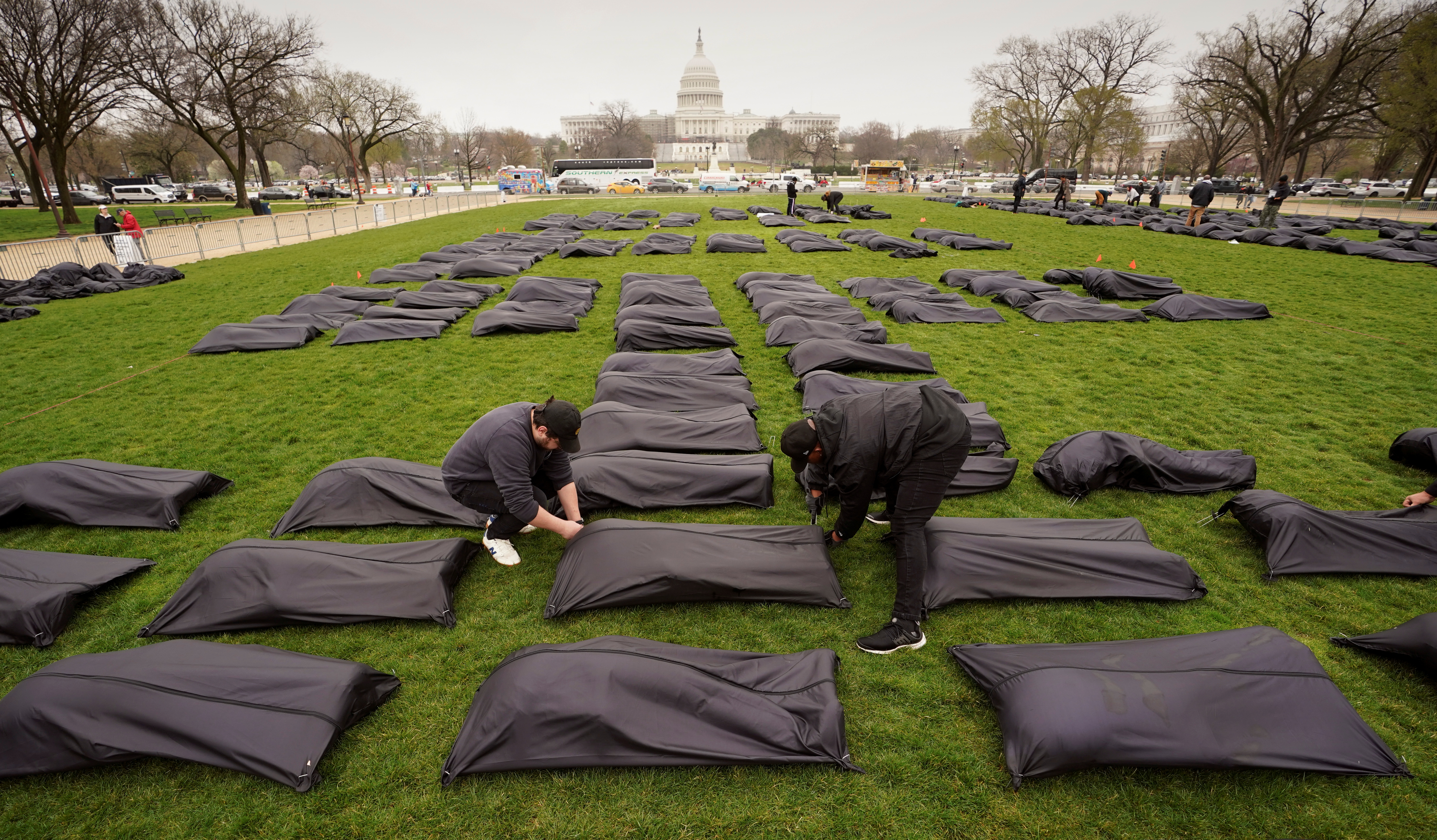 Gun control activists place body bags on the National Mall in Washington