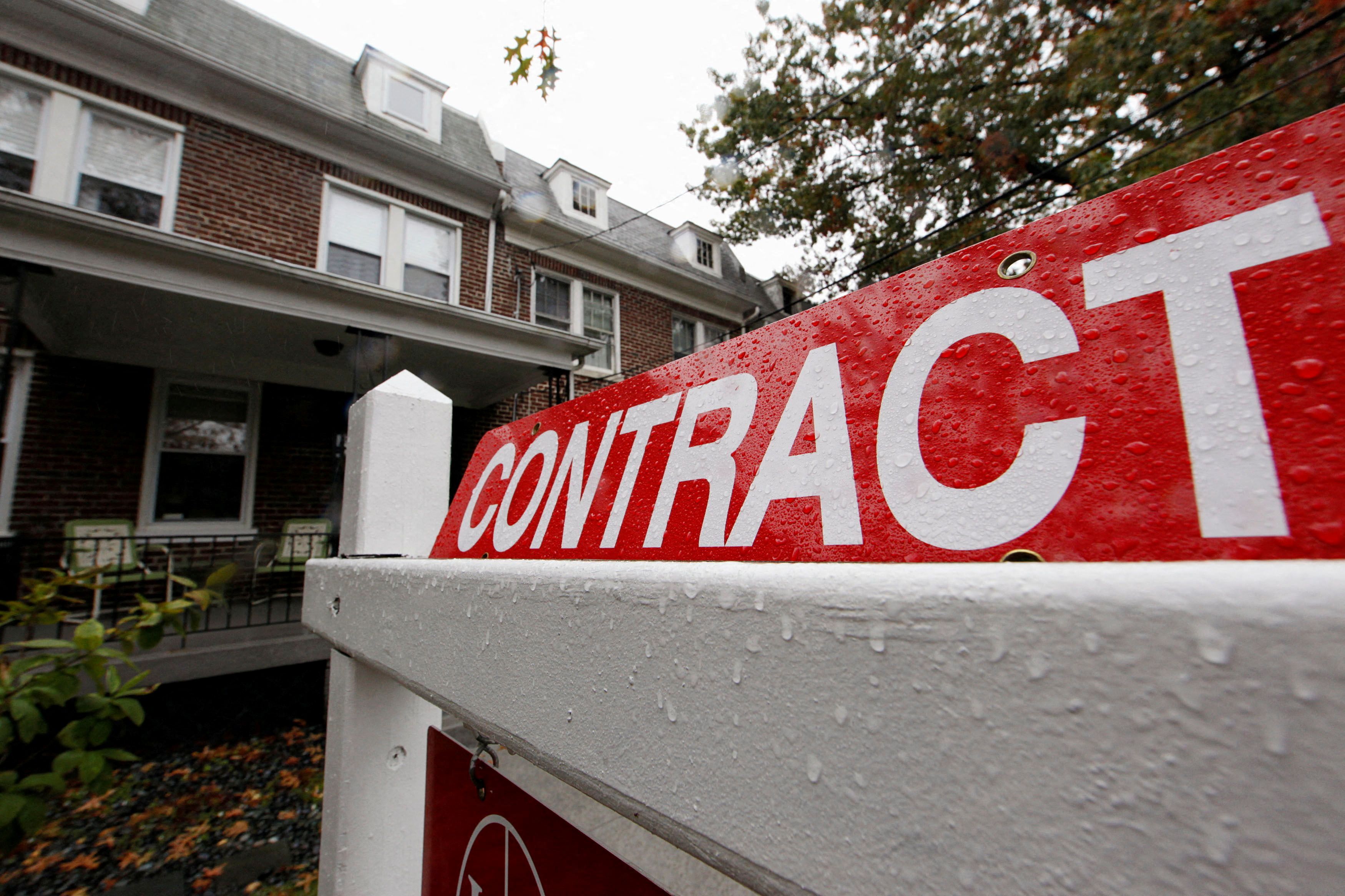 A home with a sign indicating that it is under contract to be sold is seen in a neighborhood of downtown Washington