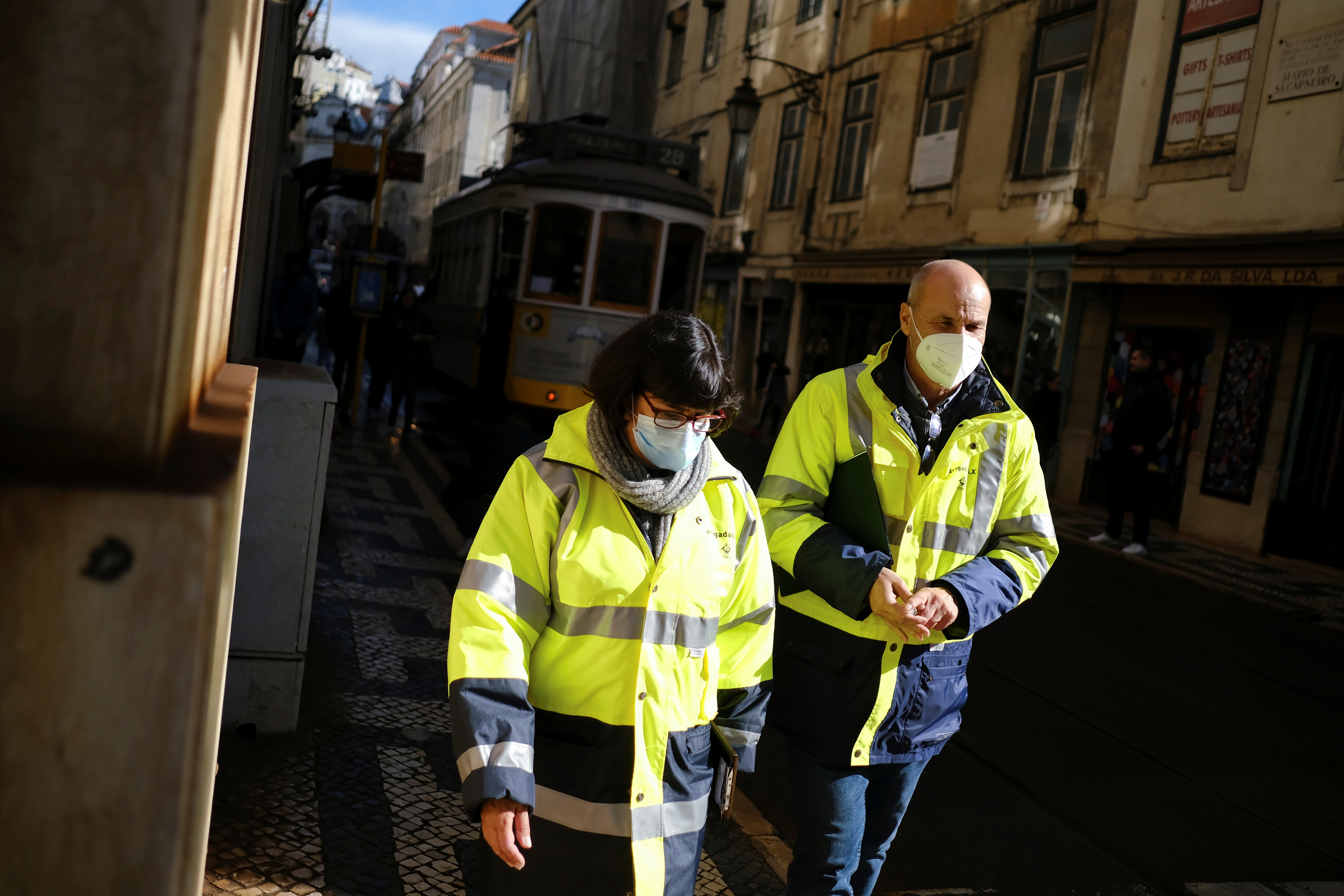 People wearing protective masks due to coronavirus disease (COVID-19) pandemic walk in central Lisbon, Portugal, November 25, 2021. REUTERS/Pedro Nunes