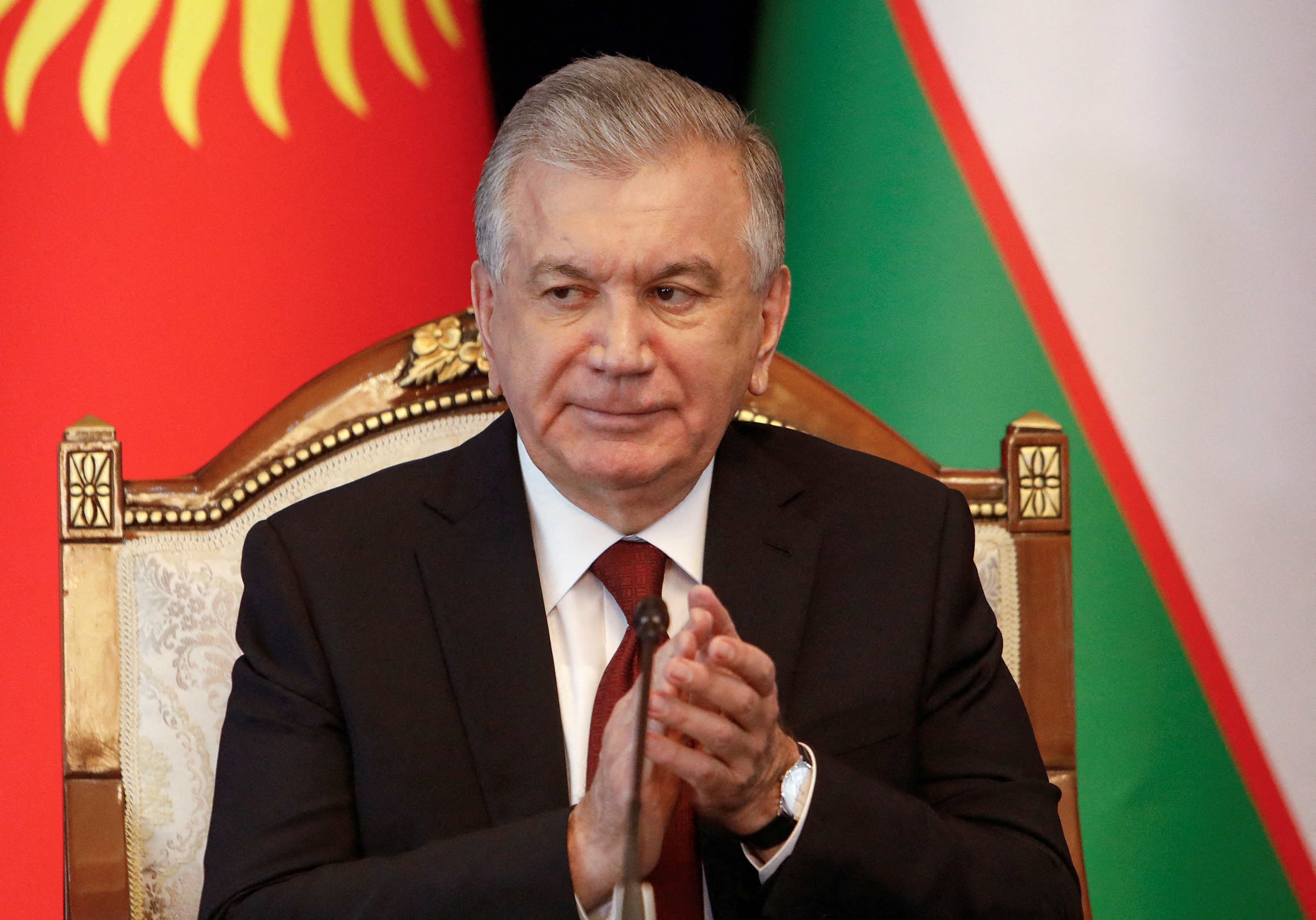 Uzbek President Shavkat Mirziyoyev applauds during a signing ceremony and news conference while on a visit to Bishkek, Kyrgyzstan