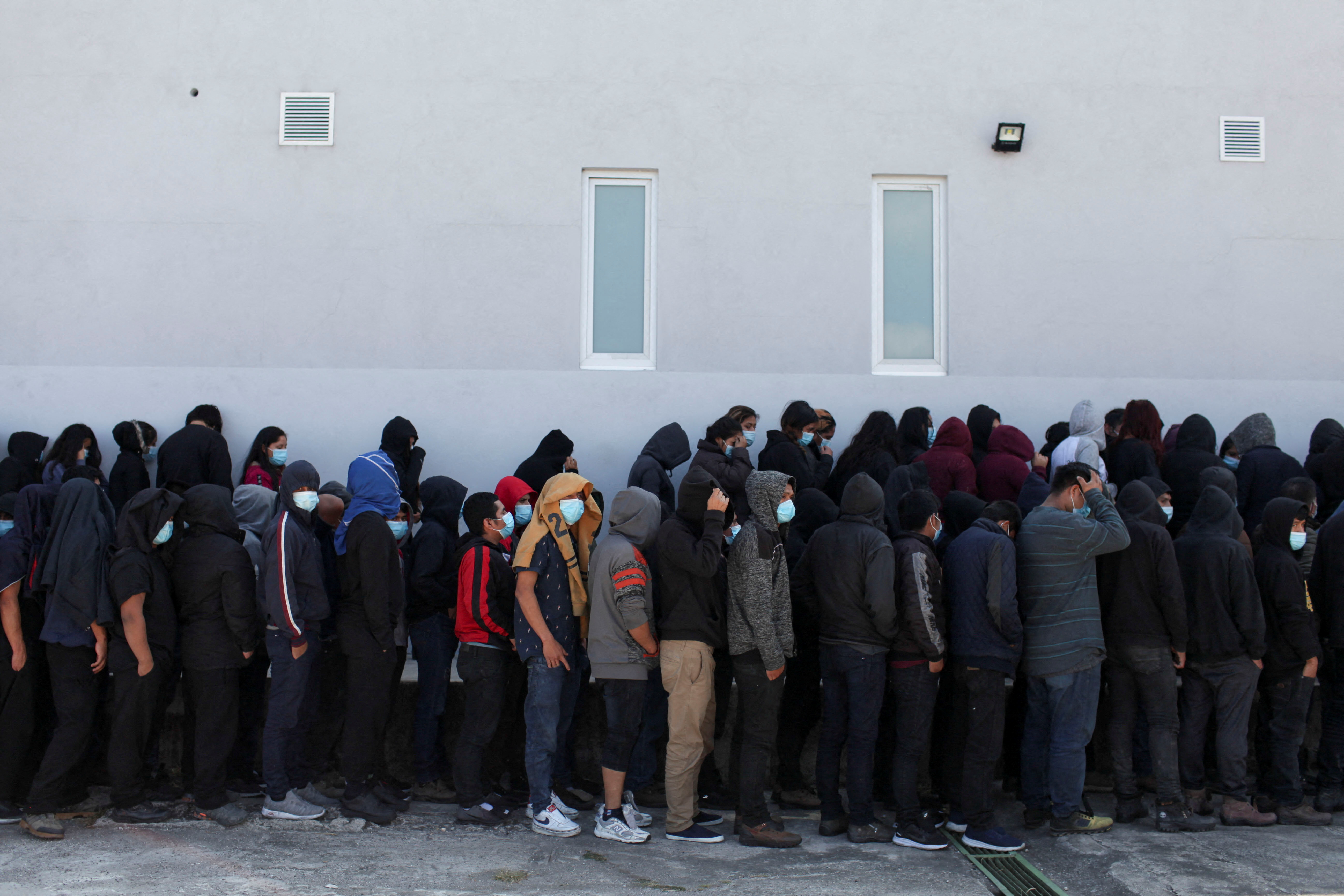 Guatemalan deportees queue outside a government migration facility after arriving on a deportation flight from the U.S., at the Guatemalan Air Force (FAG) headquarters in La Aurora International airport, in Guatemala City, Guatemala December 28, 2021. REUTERS/Sandra Sebastian