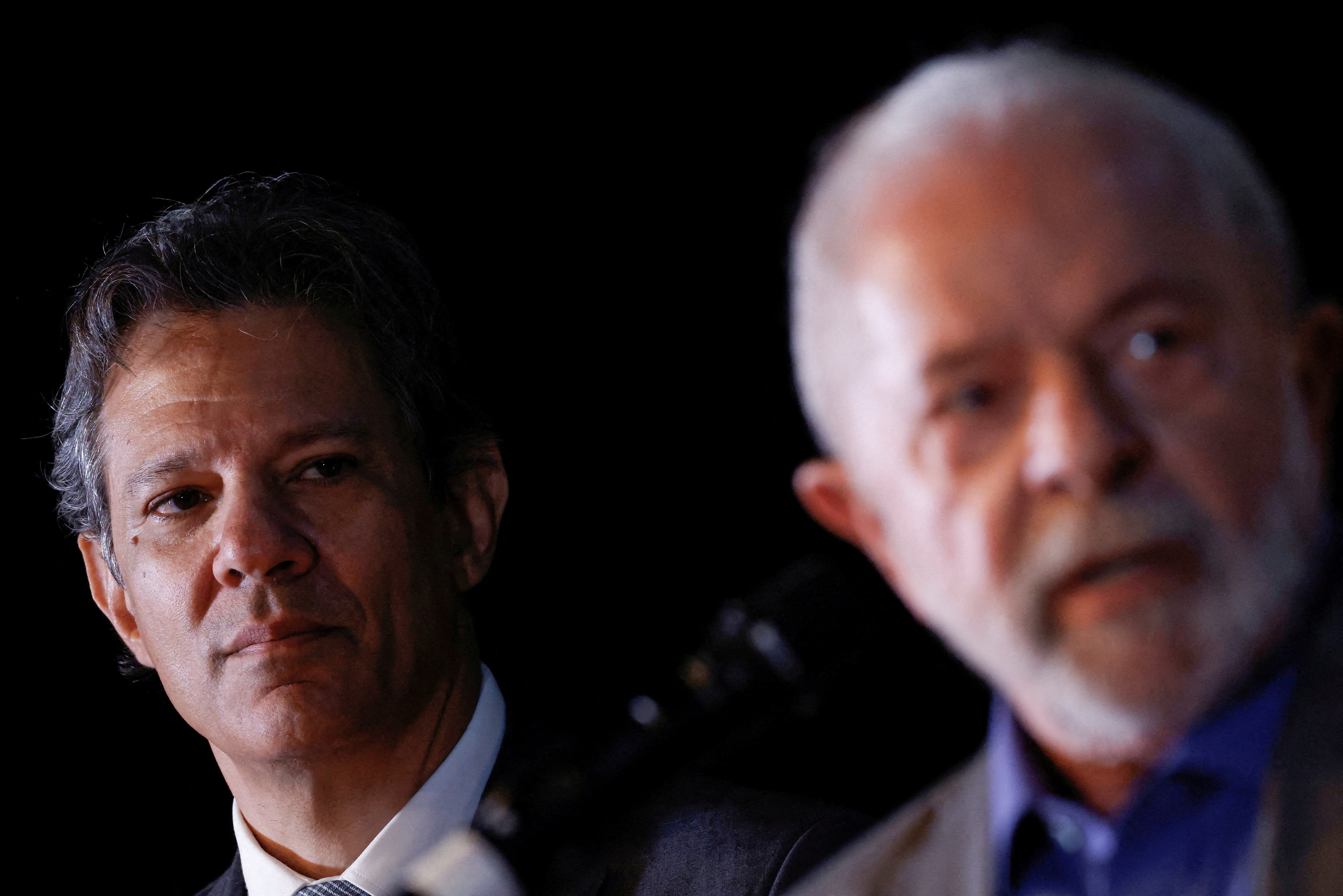 Brazil's economy minister nominee Fernando Haddad looks on as President-elect Luiz Inacio Lula da Silva talks during a news conference at the transition government building in Brasilia