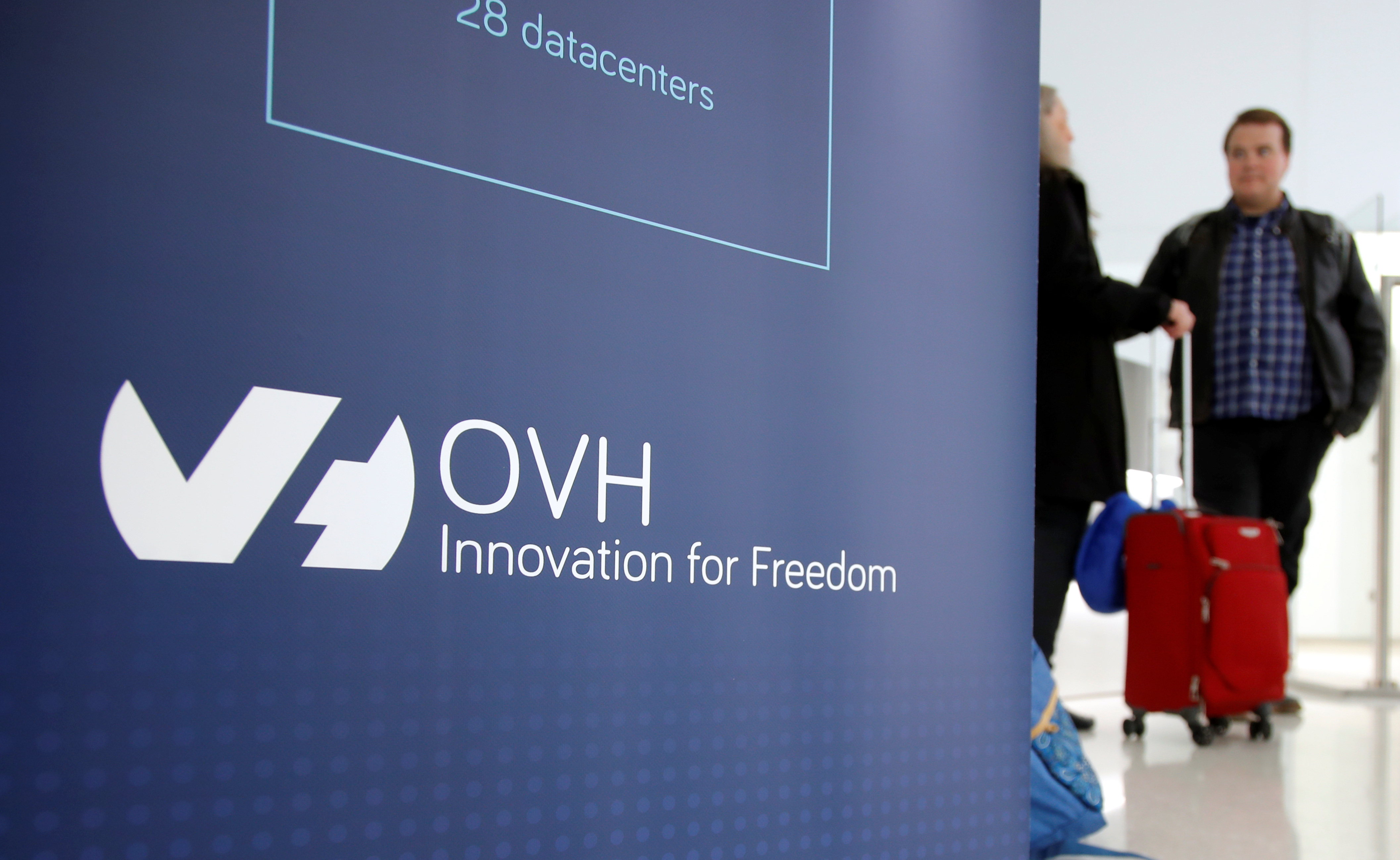 Visitors stand at the French web-hosting and server provider OVH Group new headquarters in Paris,