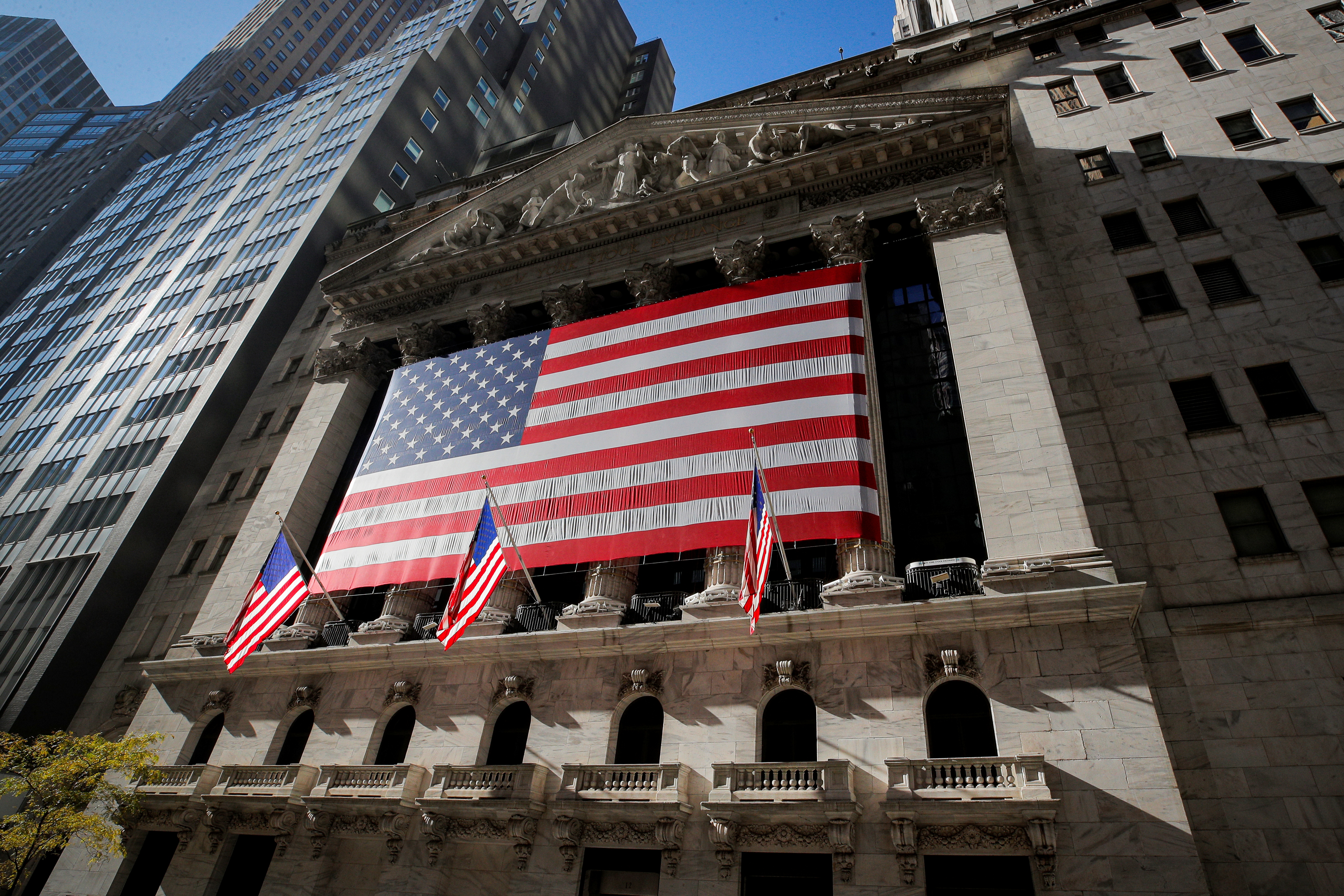 The U.S. flag covers the front facade of the New York Stock Exchange (NYSE) in New York City, New York, U.S., November 9, 2020. REUTERS/Brendan McDermid