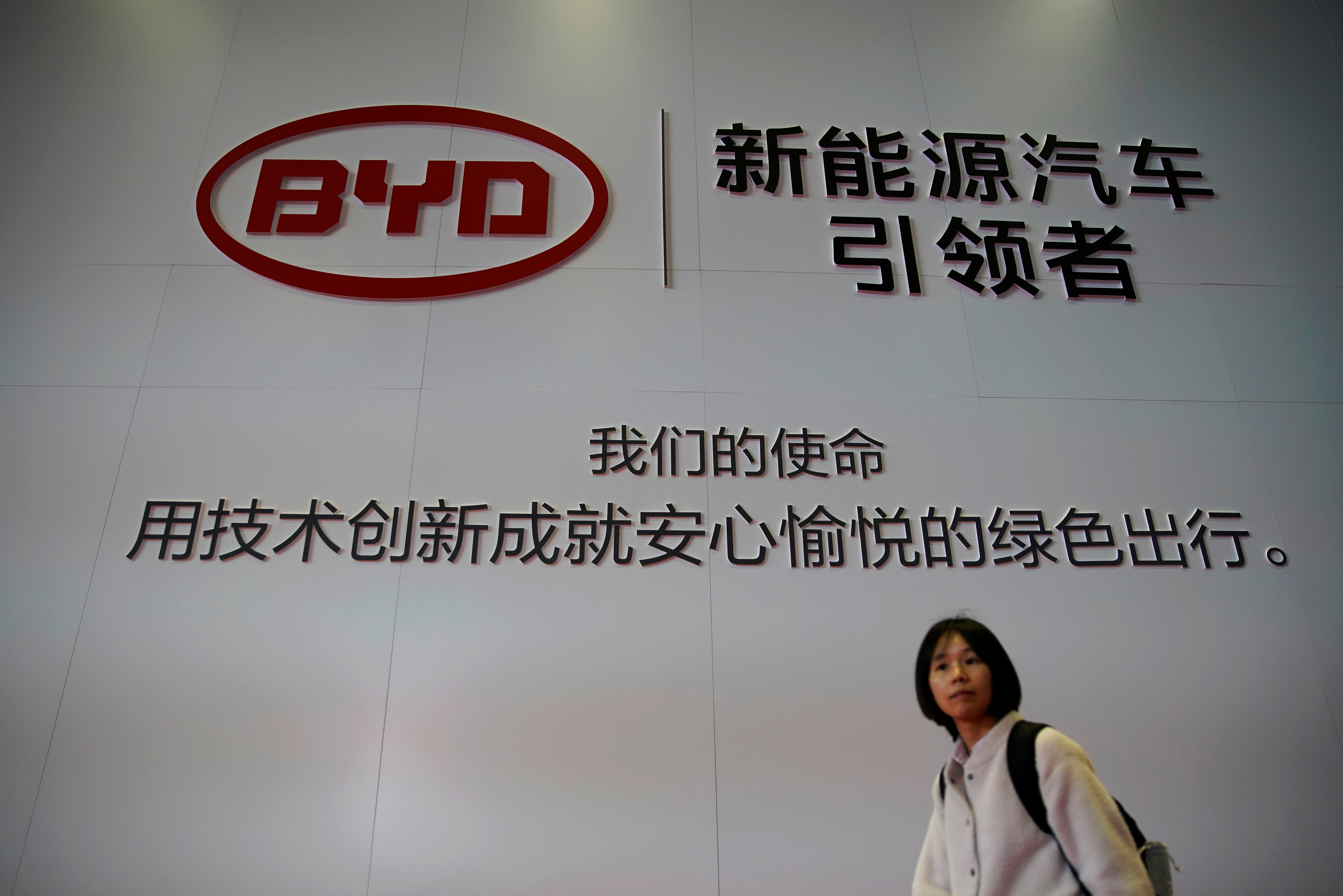 A woman walks past a BYD sign at the second media day for the Shanghai auto show in Shanghai, China April 17, 2019.  REUTERS/Aly Song