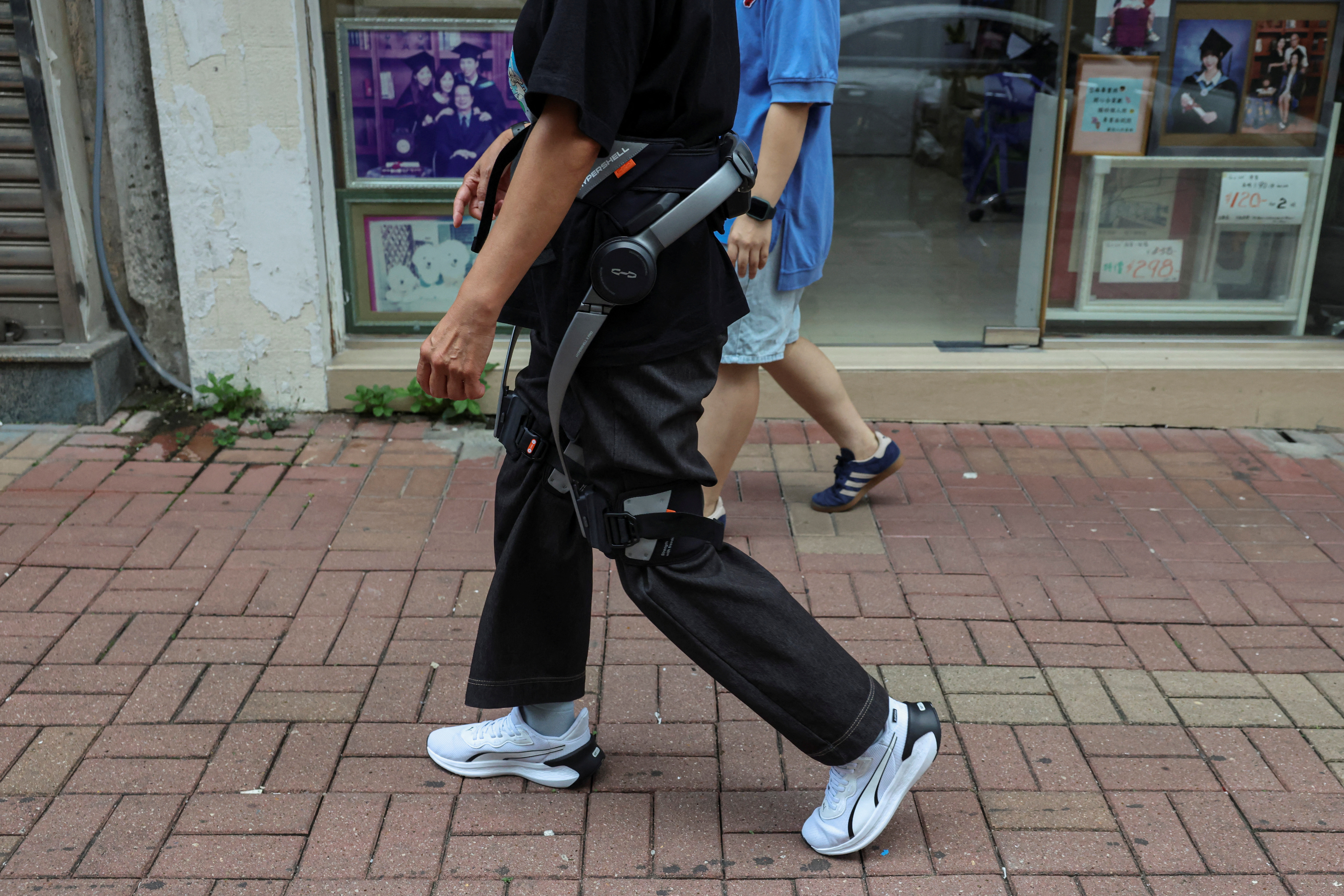 Robotic legs help elderly Hong Kong fire survivors climb back for  belongings | Reuters