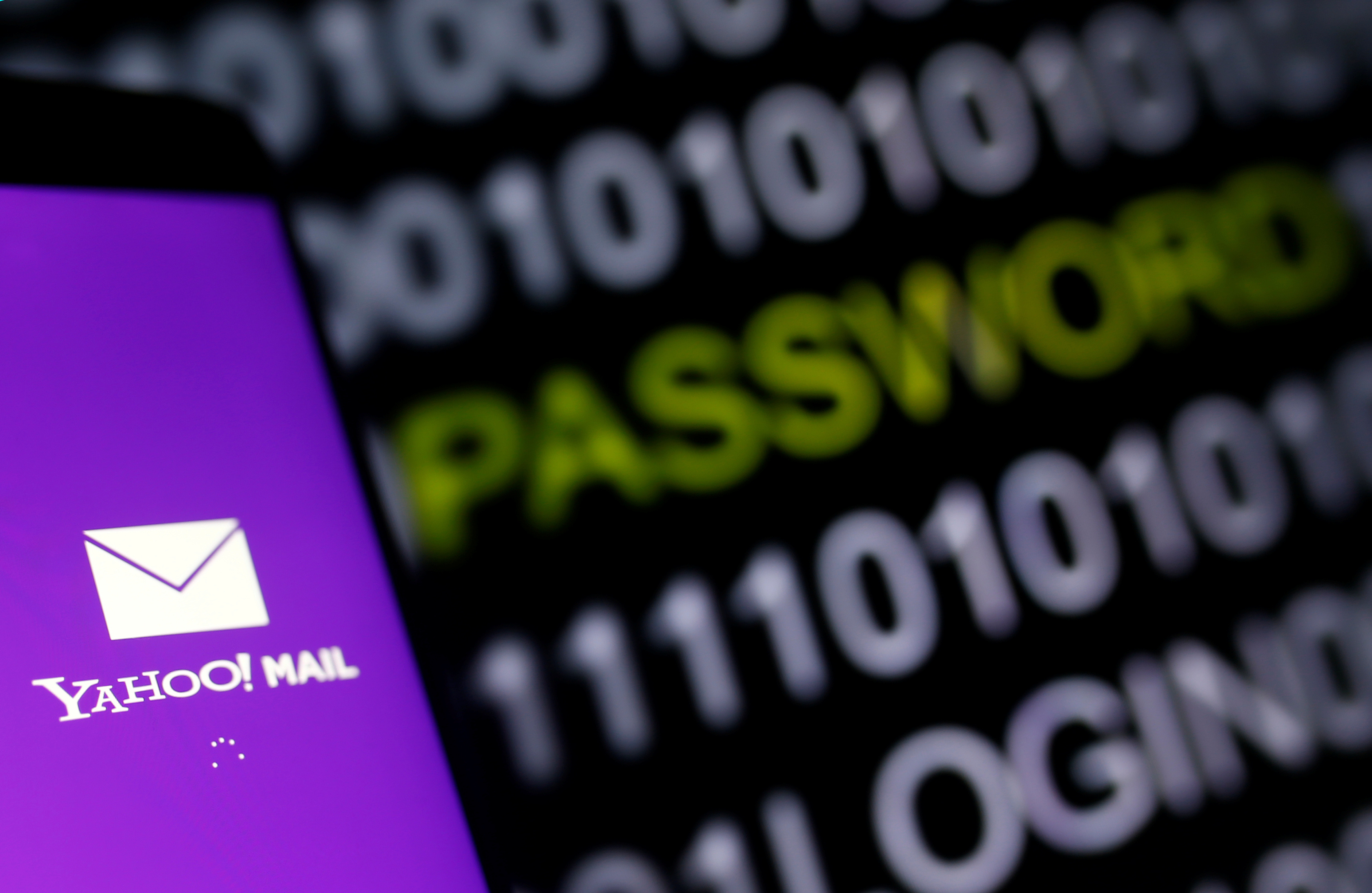 Yahoo Mail logo is displayed on a smartphone's screen in front of a code in this illustration