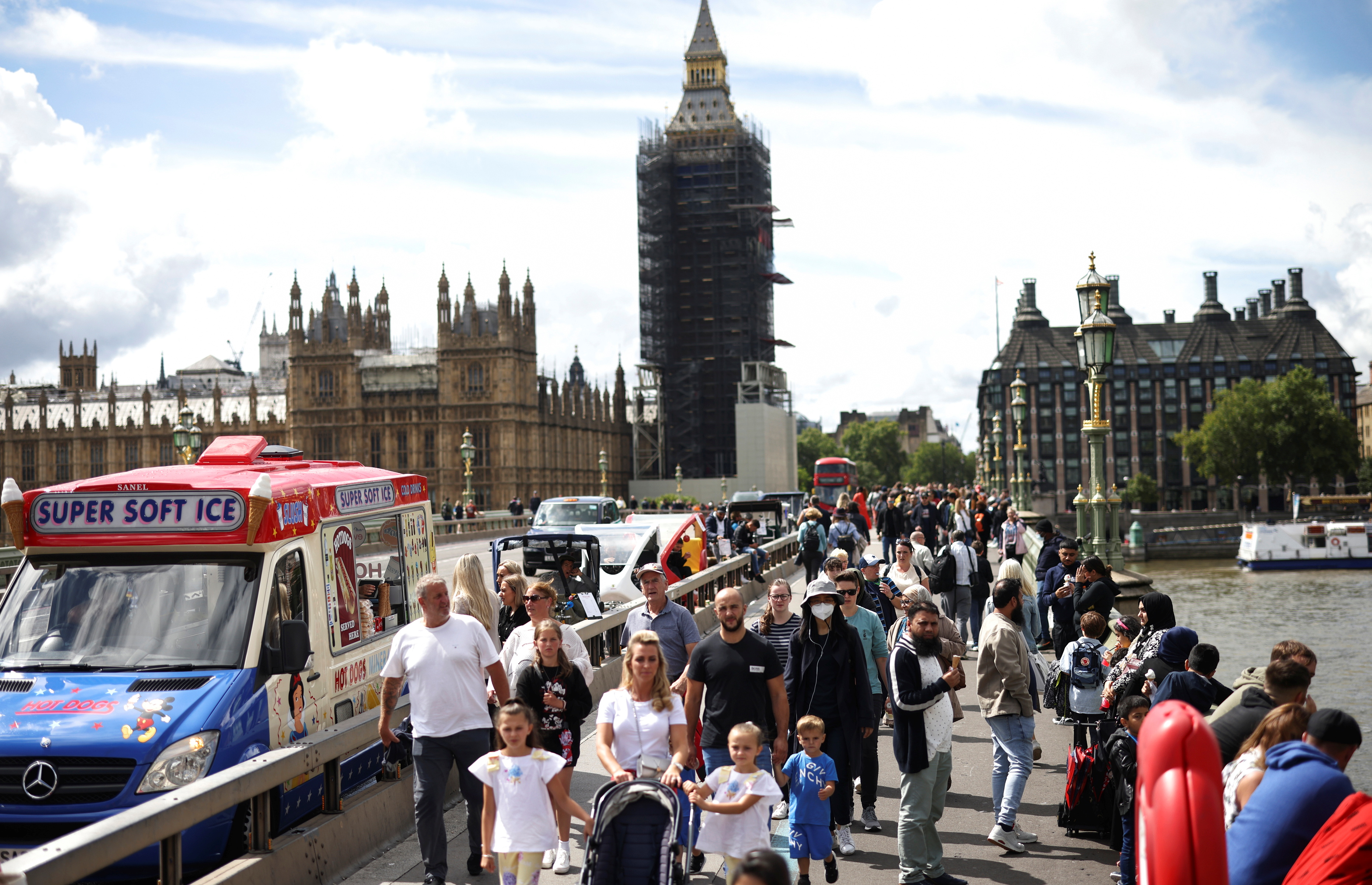 People walk over Westminster Bridge, amid the coronavirus disease (COVID-19) pandemic, in London, Britain, August 7, 2021. REUTERS/Henry Nicholls