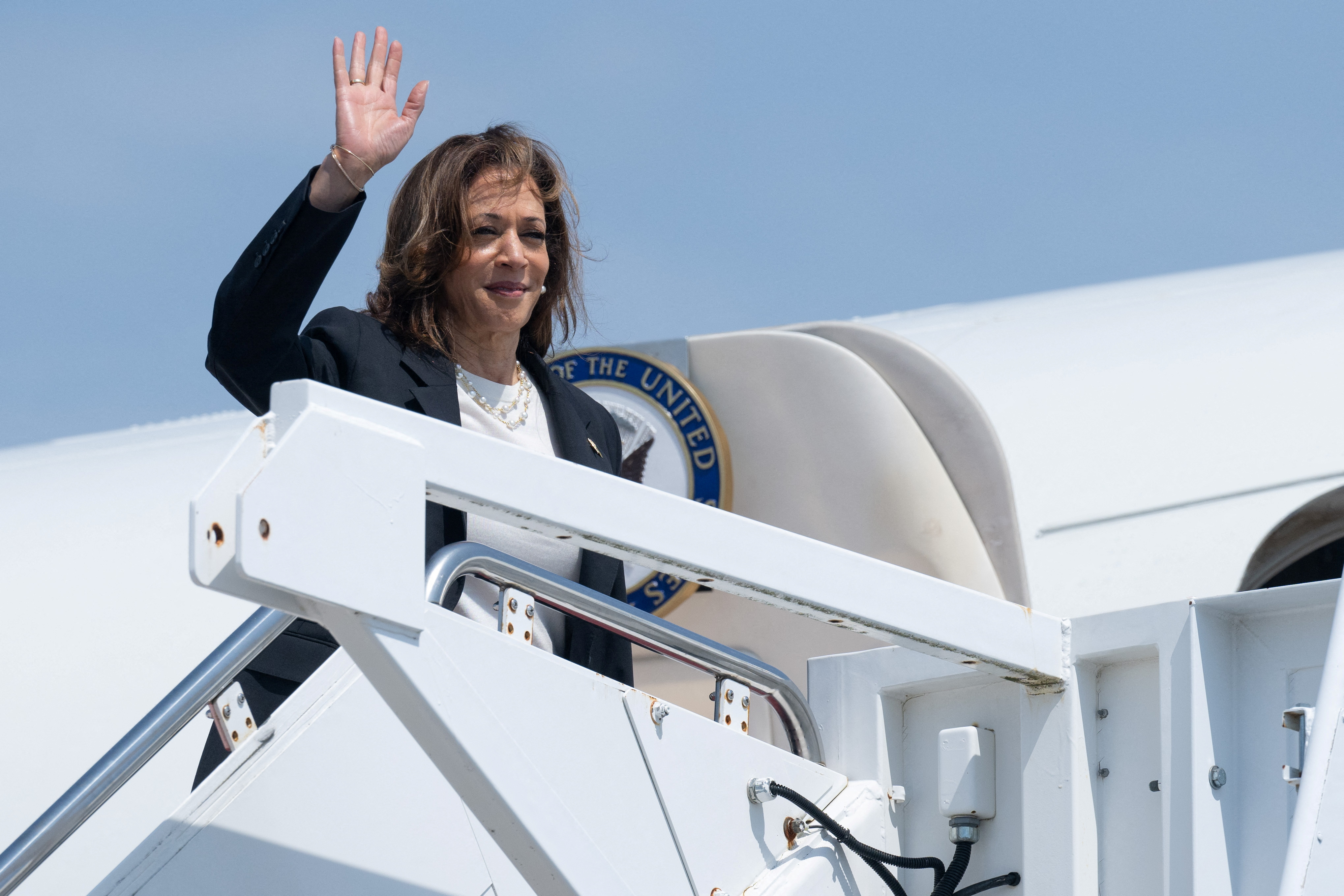 U.S. Vice President Kamala Harris waves as she boards Air Force Two to depart from Joint Base Andrews in Maryland