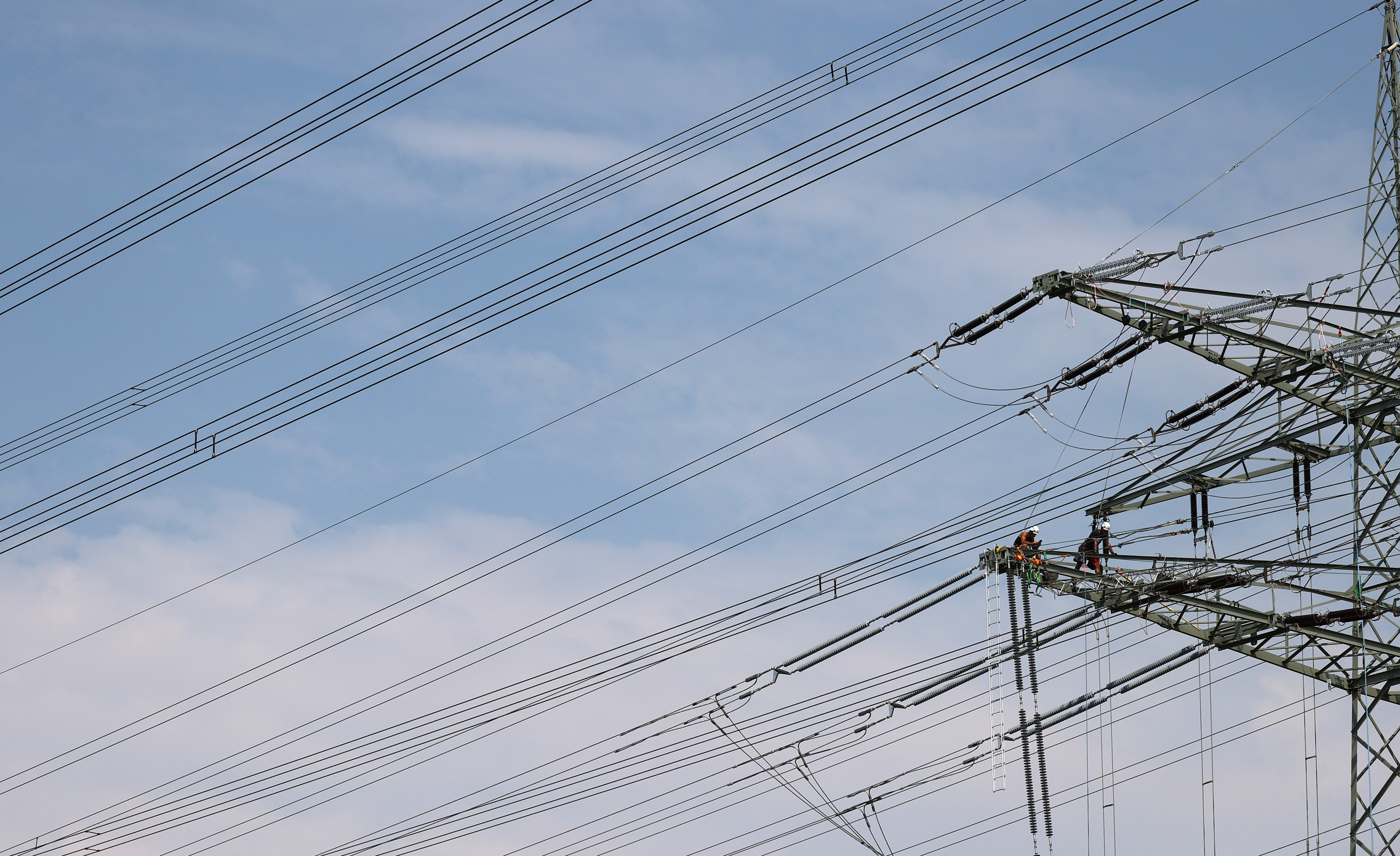 Workers install new high voltage power lines near Hanau, Germany, August 10, 2020. REUTERS/Kai Pfaffenbach