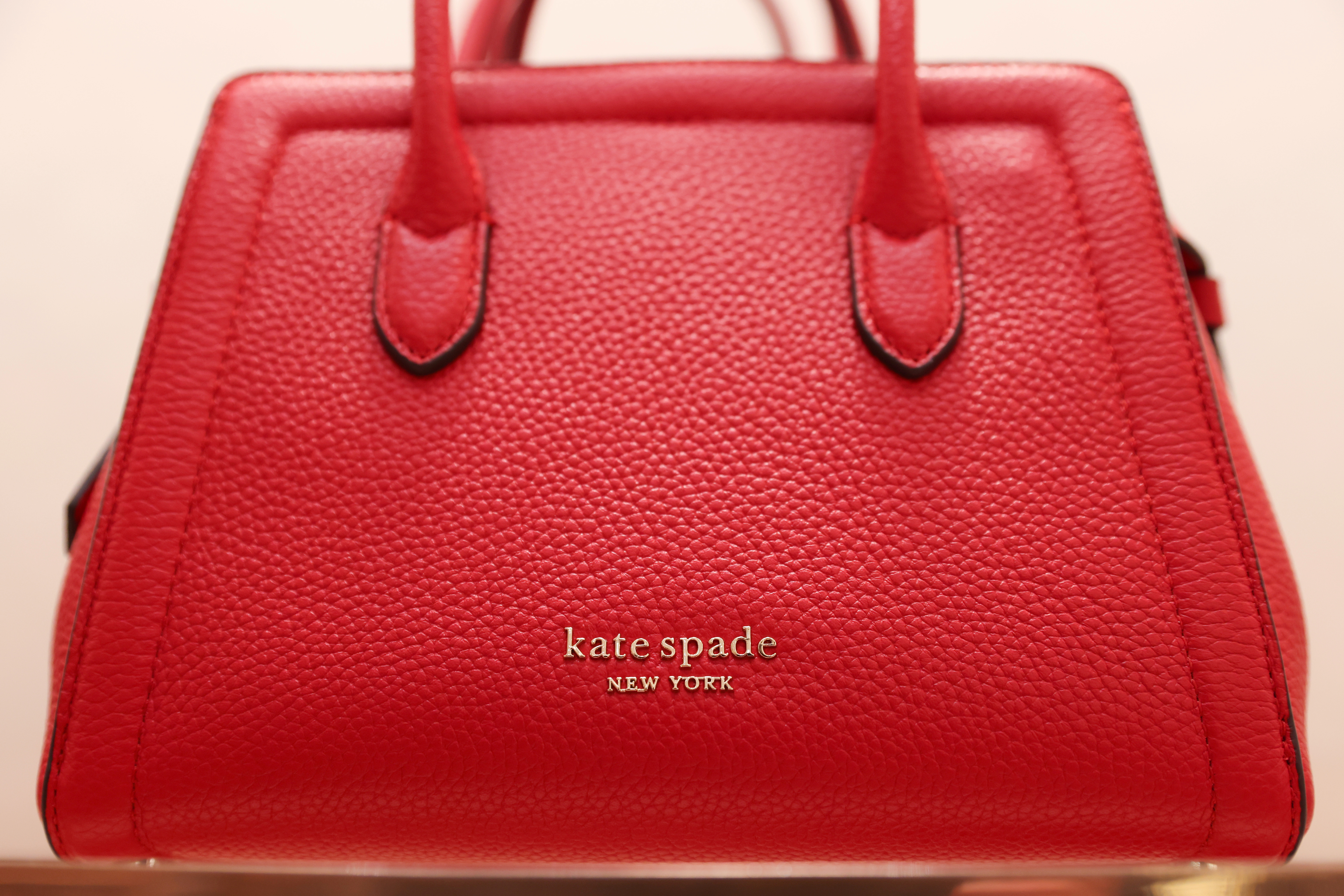 A handbag is seen in a Kate Spade store, owned by Tapestry, Inc., in Manhattan, New York