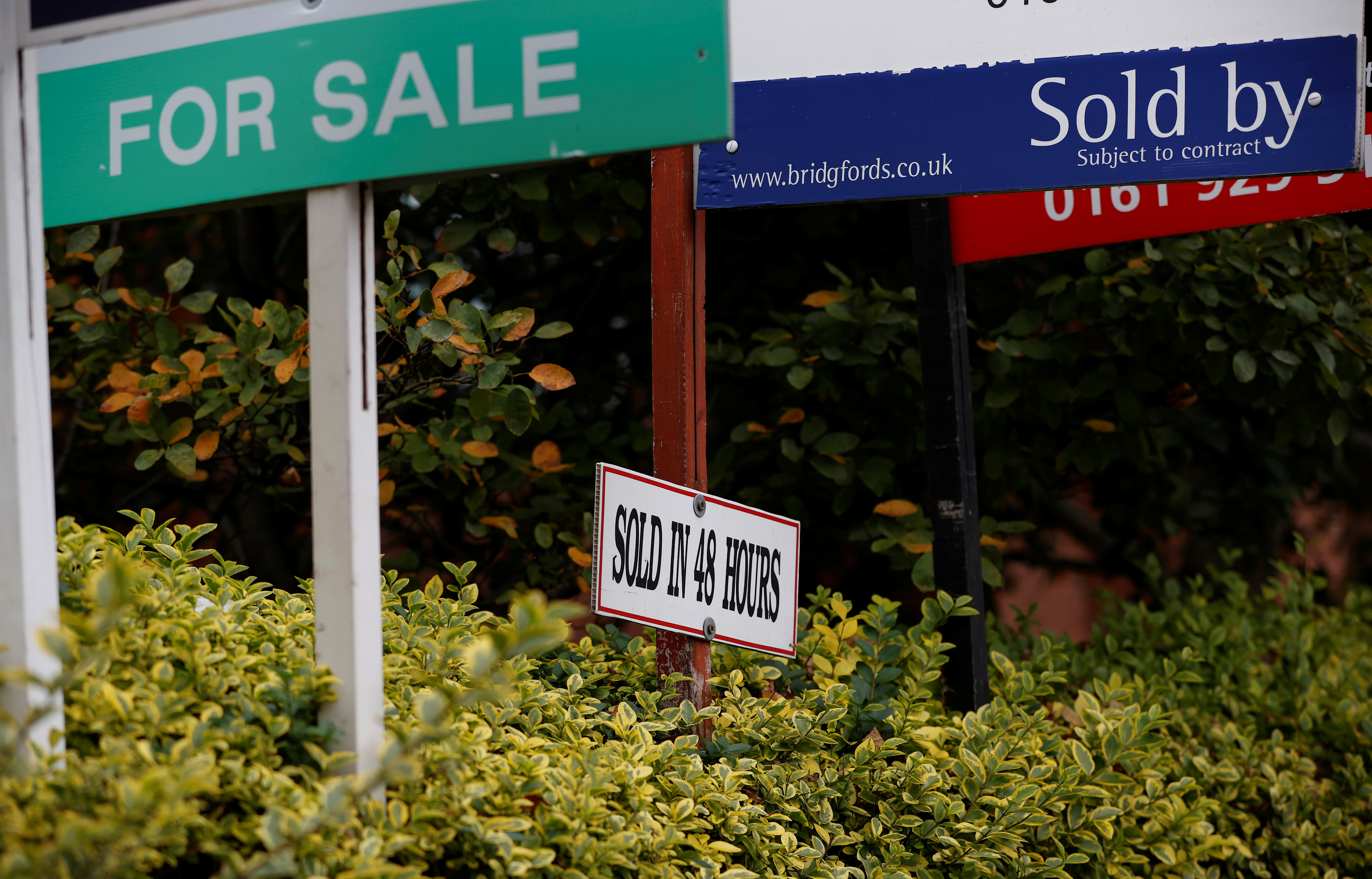Estate Agent’s boards are lined up outside a housing development in Manchester