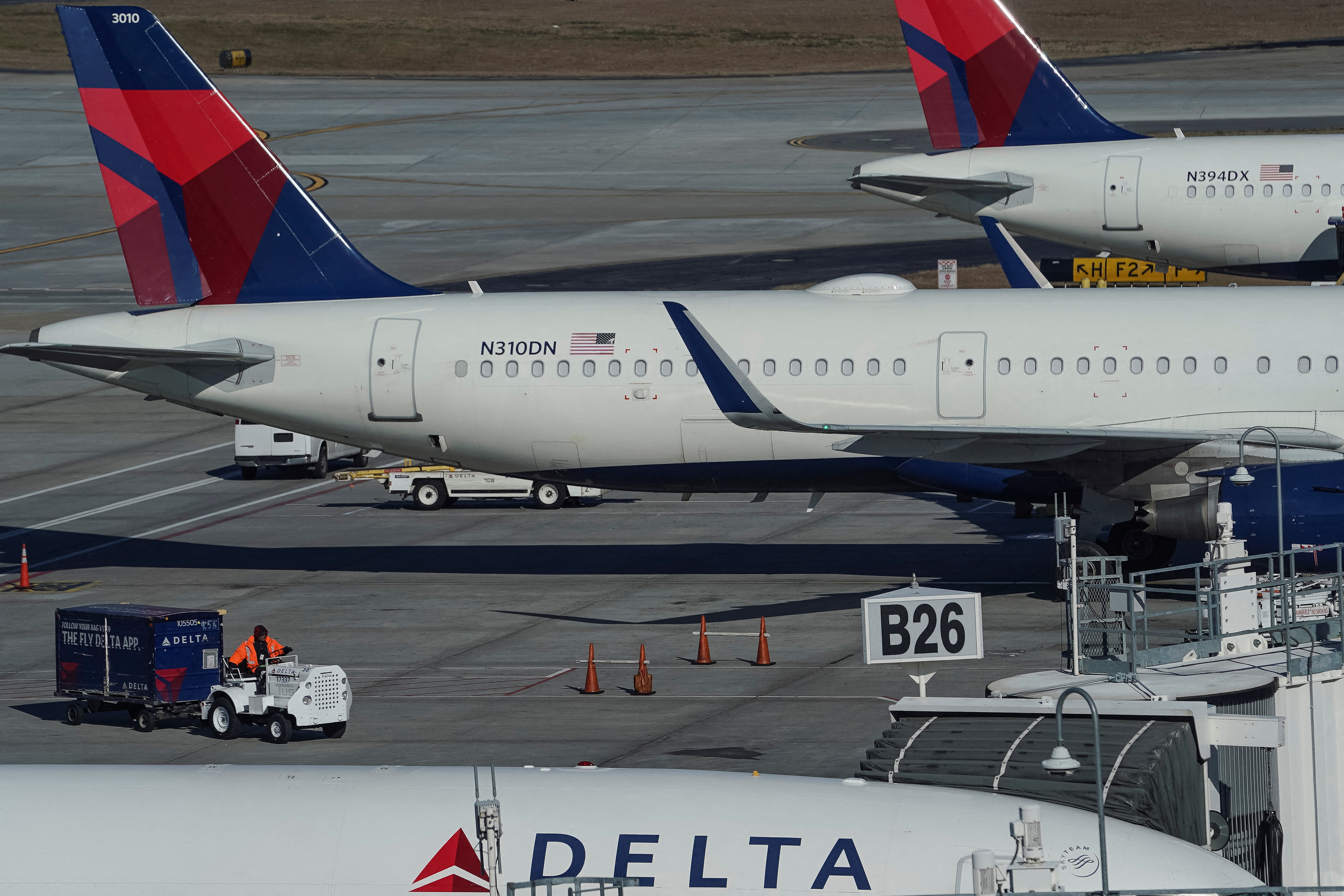 Delta Air Lines jets are seen at gates at Hartsfield-Jackson Atlanta International Airport in Atlanta, Georgia, U.S. December 22, 2021. REUTERS/Elijah Nouvelage
