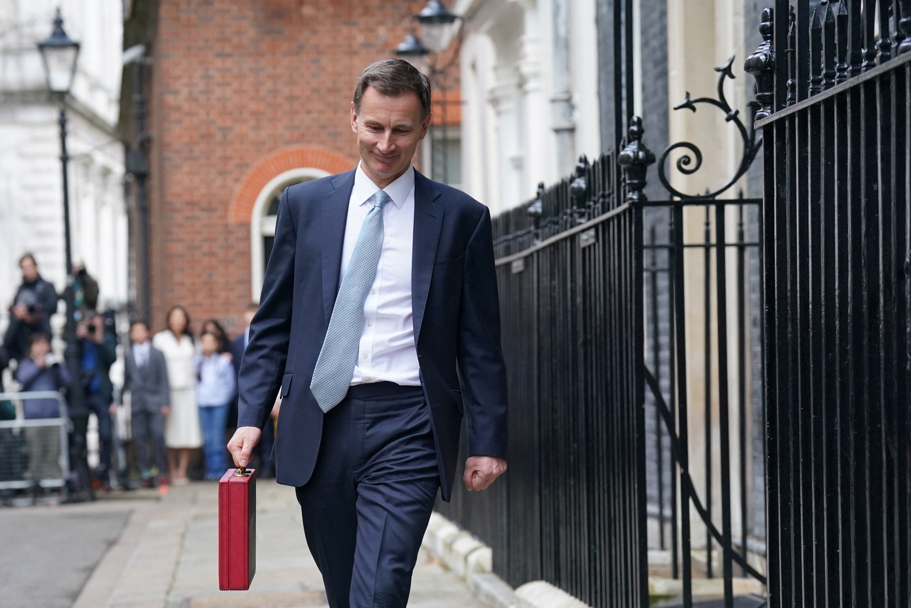 Britain's Chancellor of the Exchequer Hunt walks outside 11 Downing Street, in London