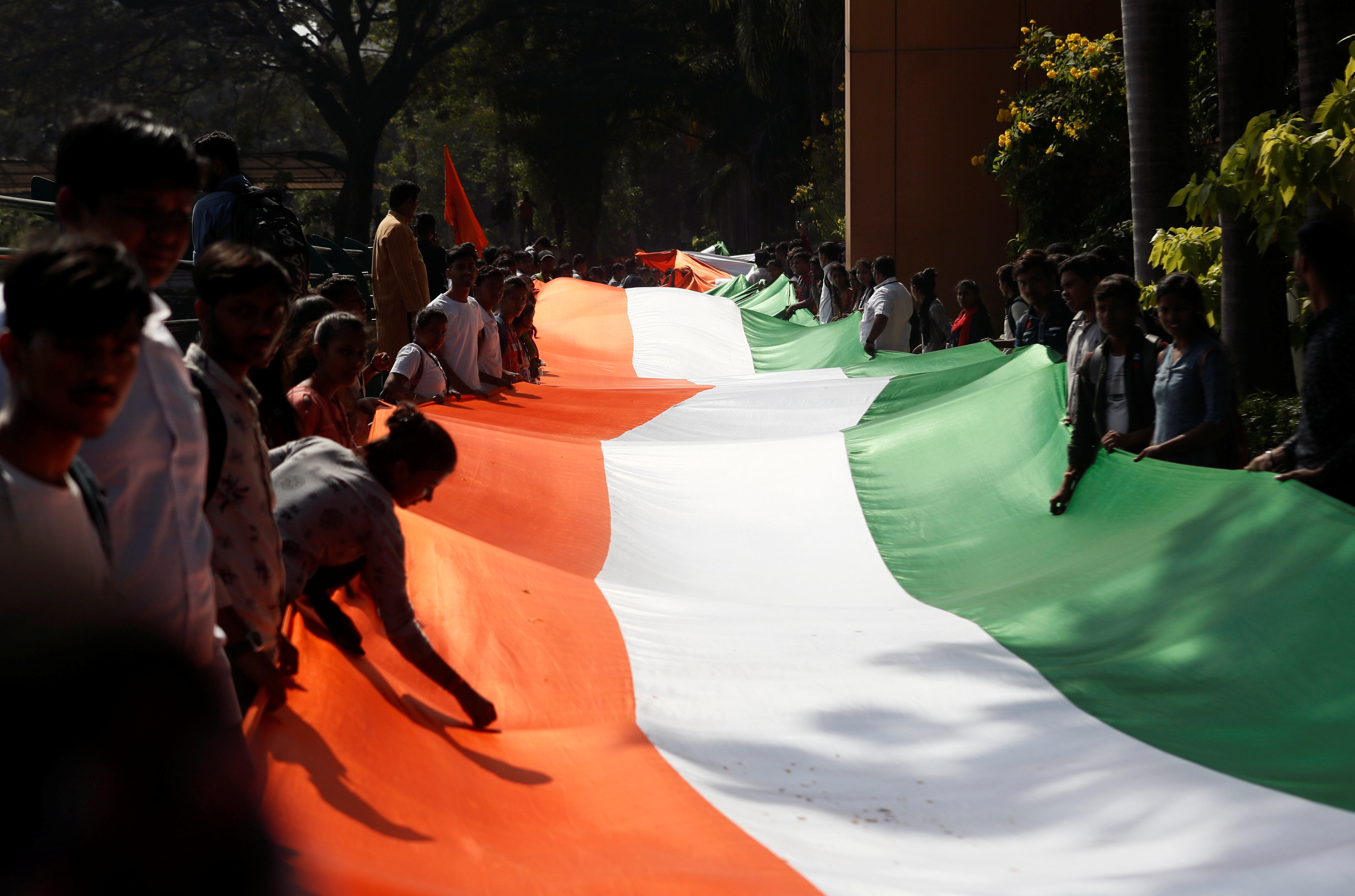 People hold an Indian national flag during a unity rally in Mumbai