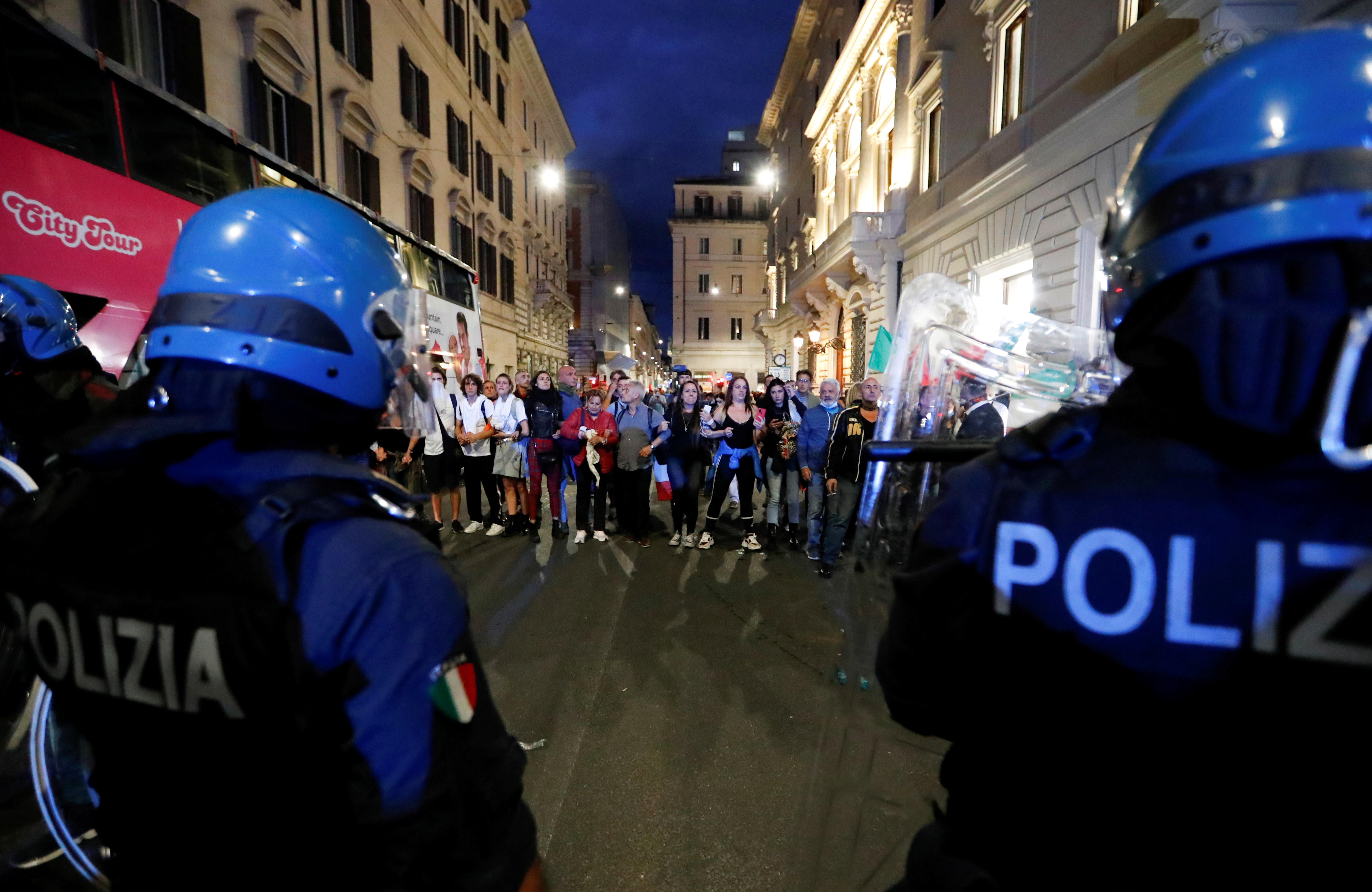 Demonstrators face off police officers during a protest against the government's introduction of the 