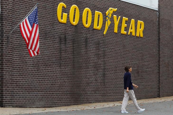 A pedestrian walks past a Goodyear Tire facility in Somerville